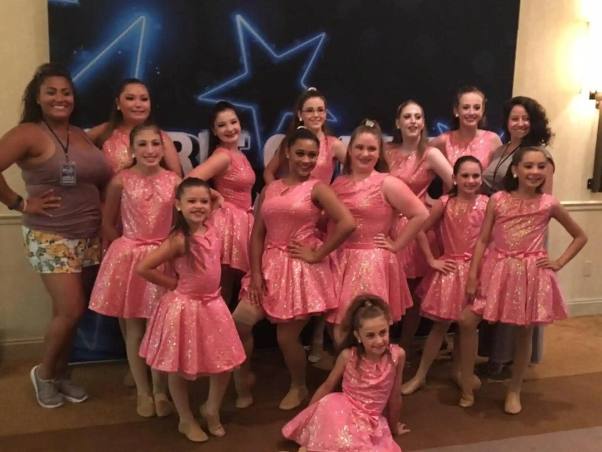 a group of girls in pink dresses