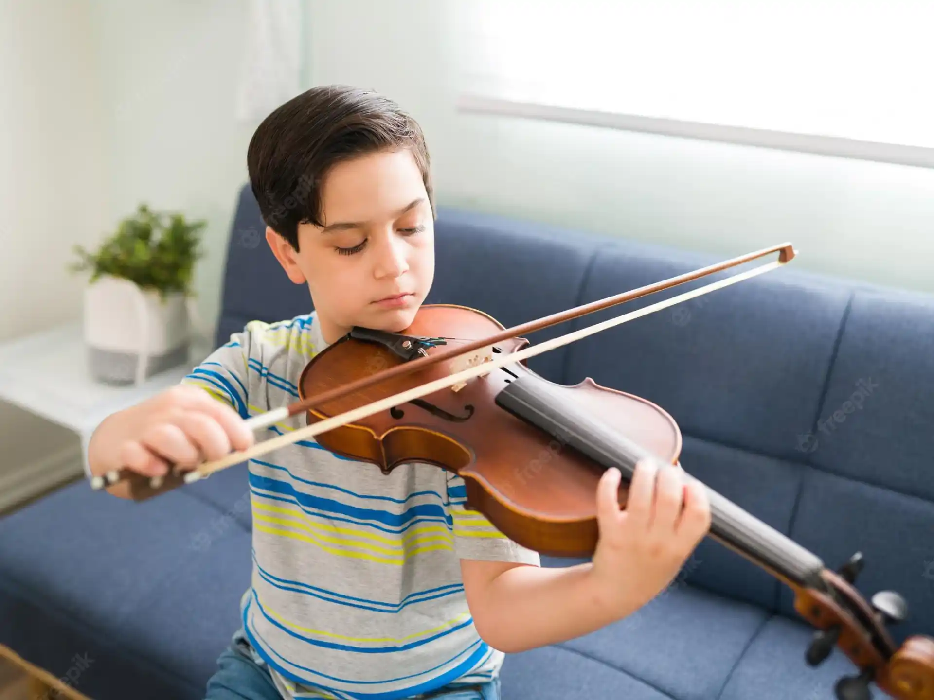 a boy playing a violin