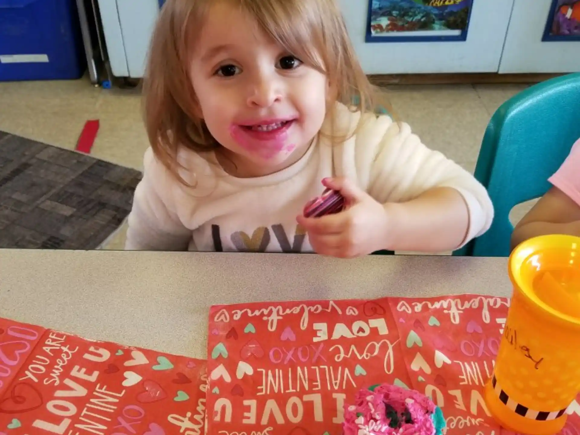 a girl sitting at a table