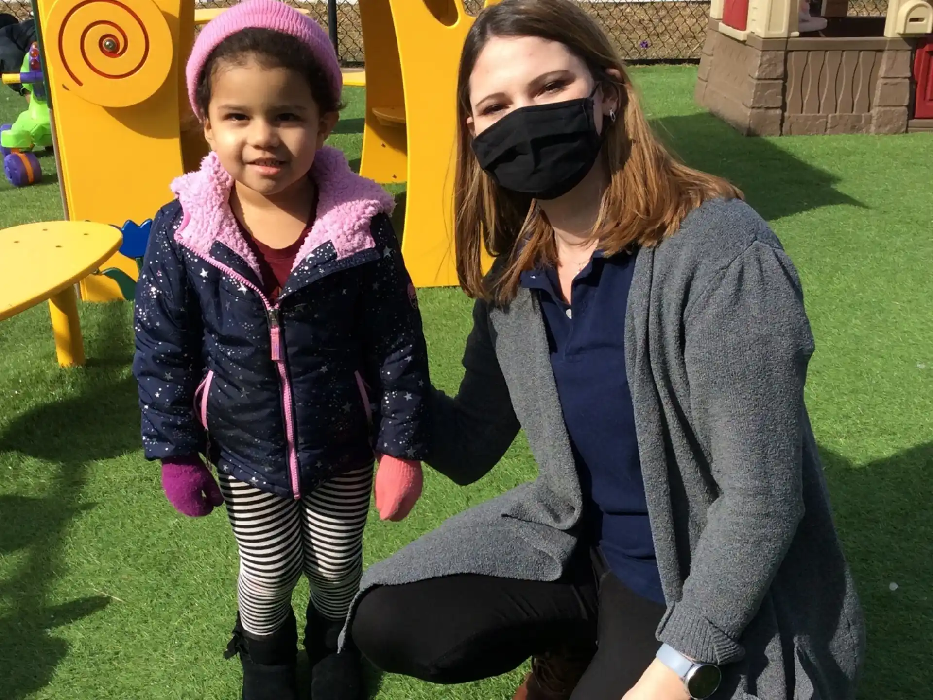 a person and a child posing for the camera