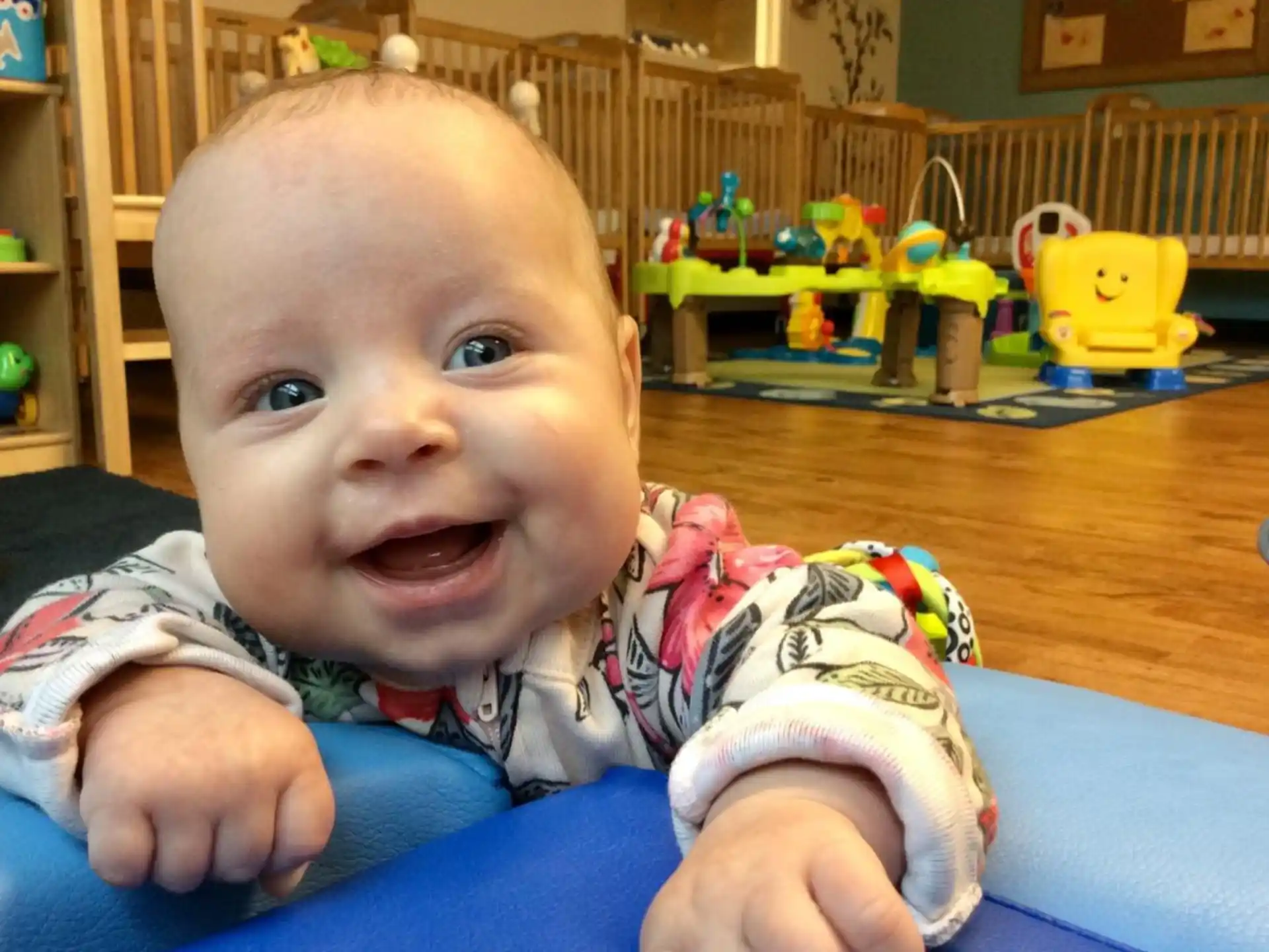 a baby sitting on a blue blanket