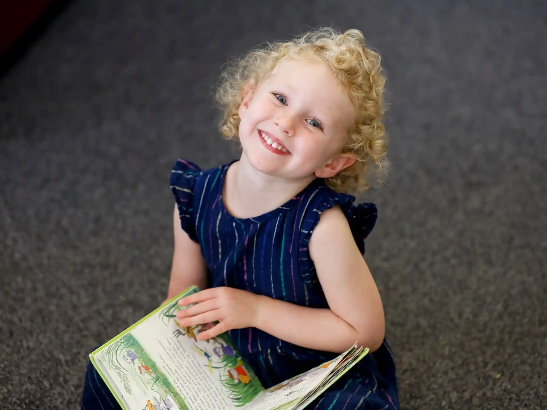 a child holding a book