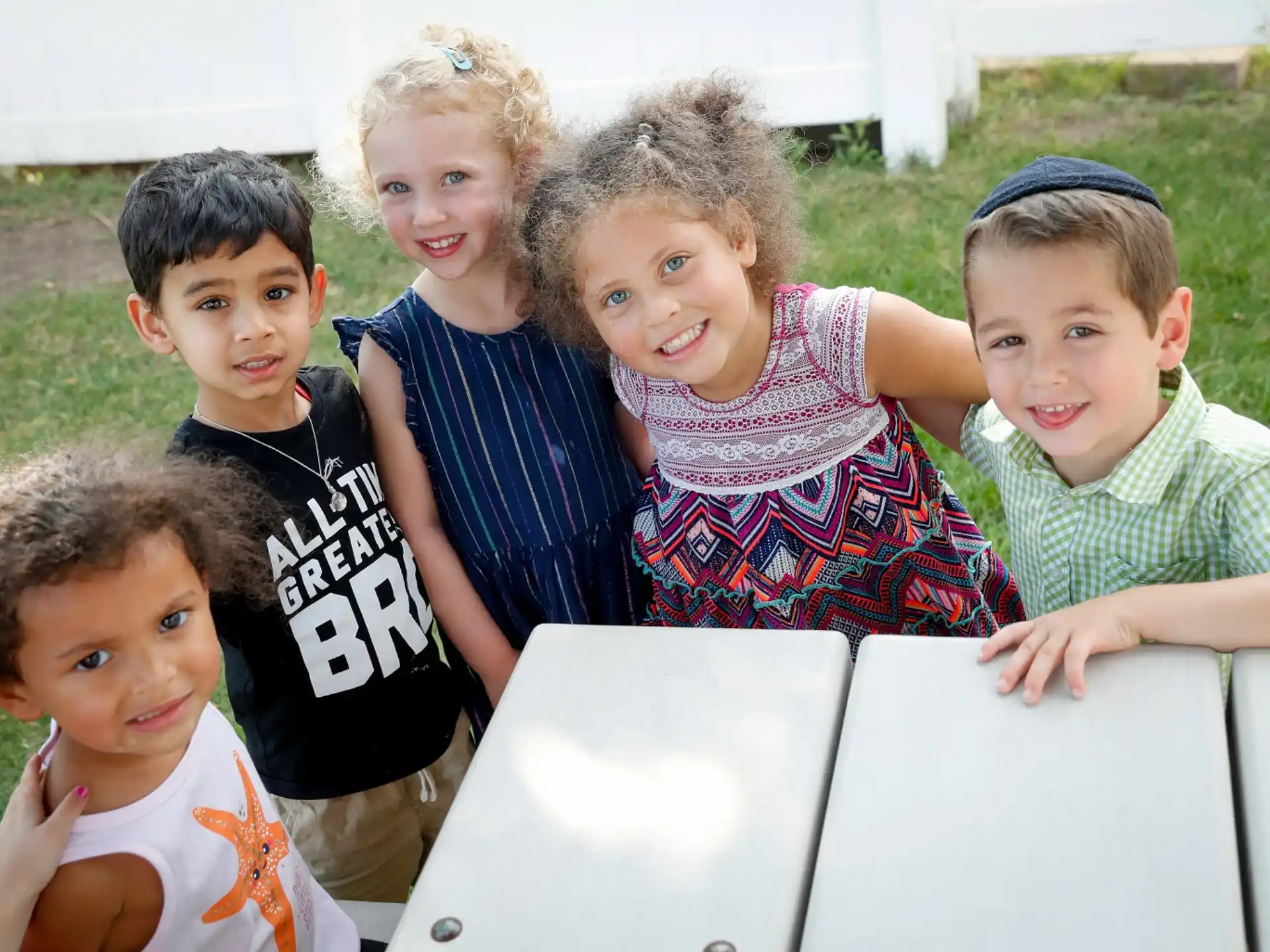 a group of children sitting on the grass