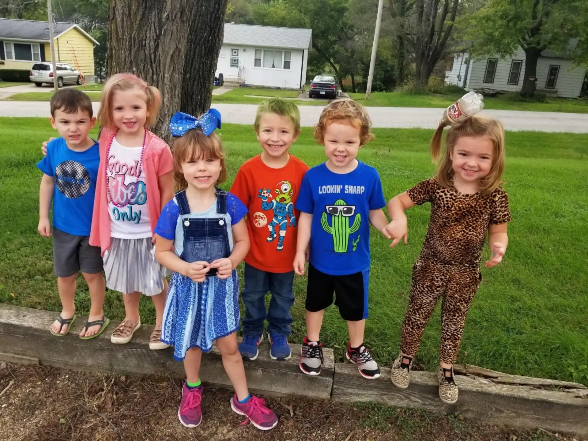 a group of children standing together outside