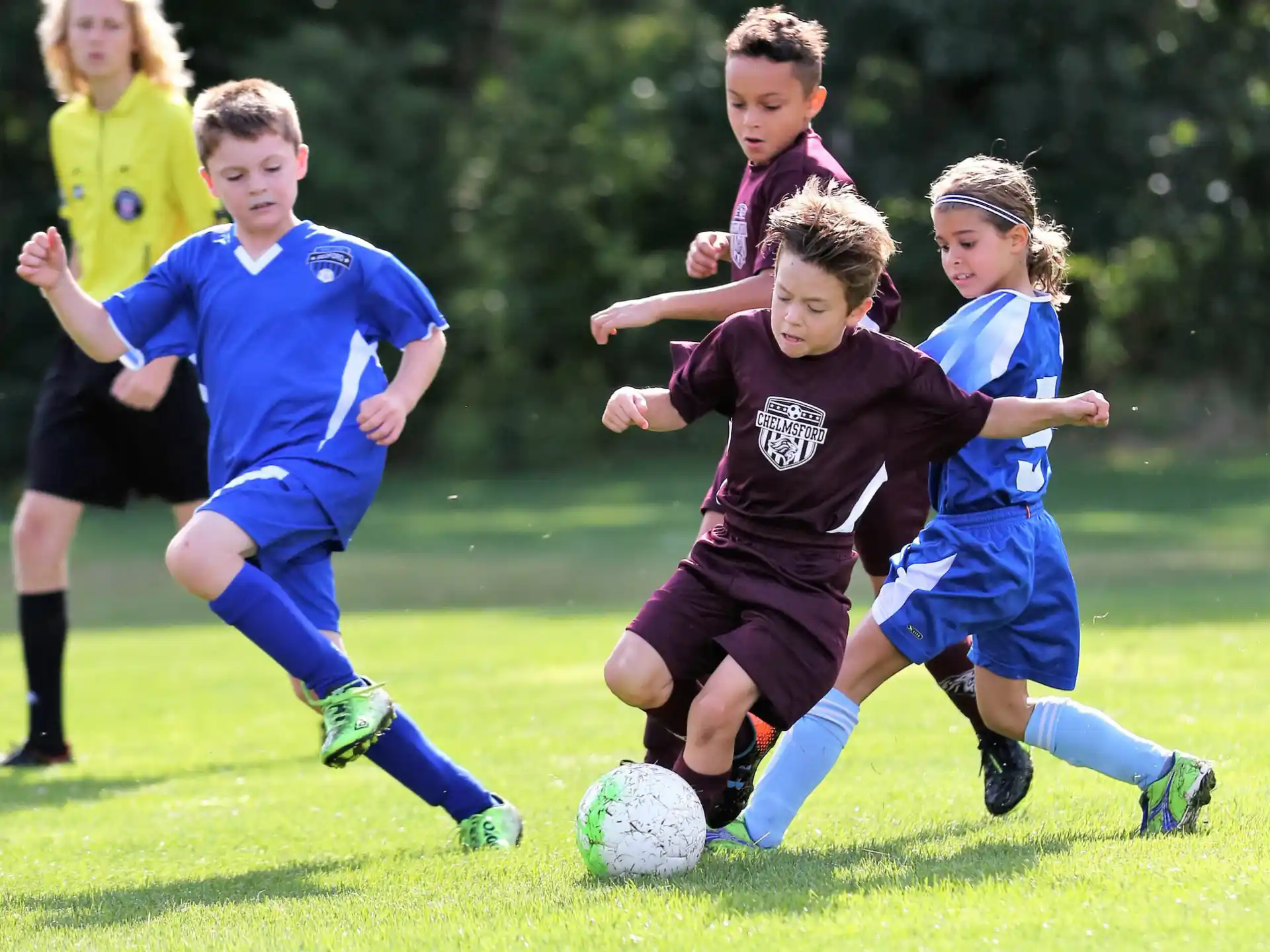 kids chasing a football ball