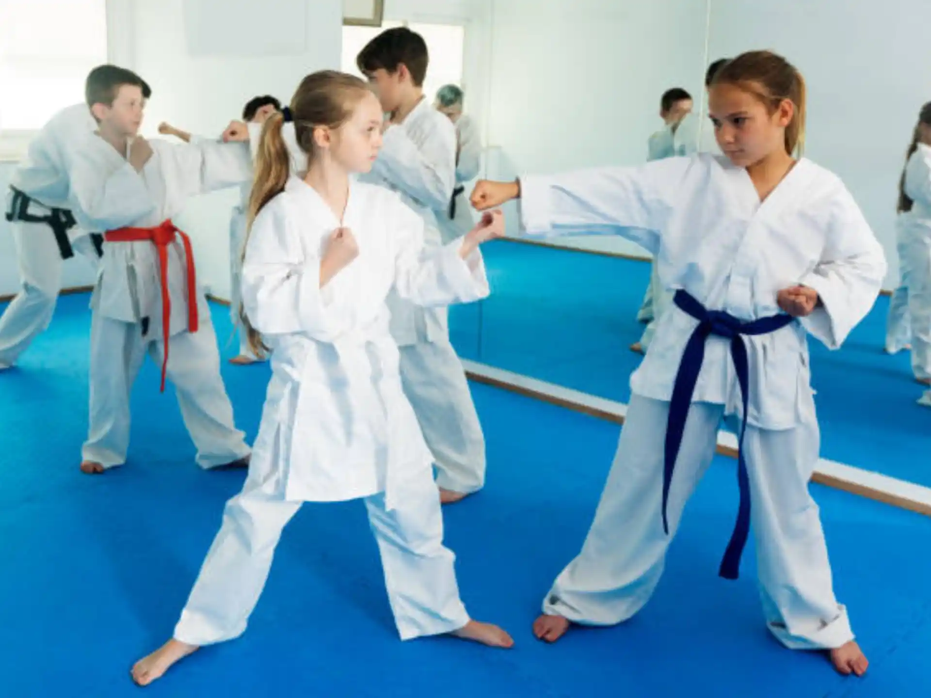 a group of people in karate uniforms
