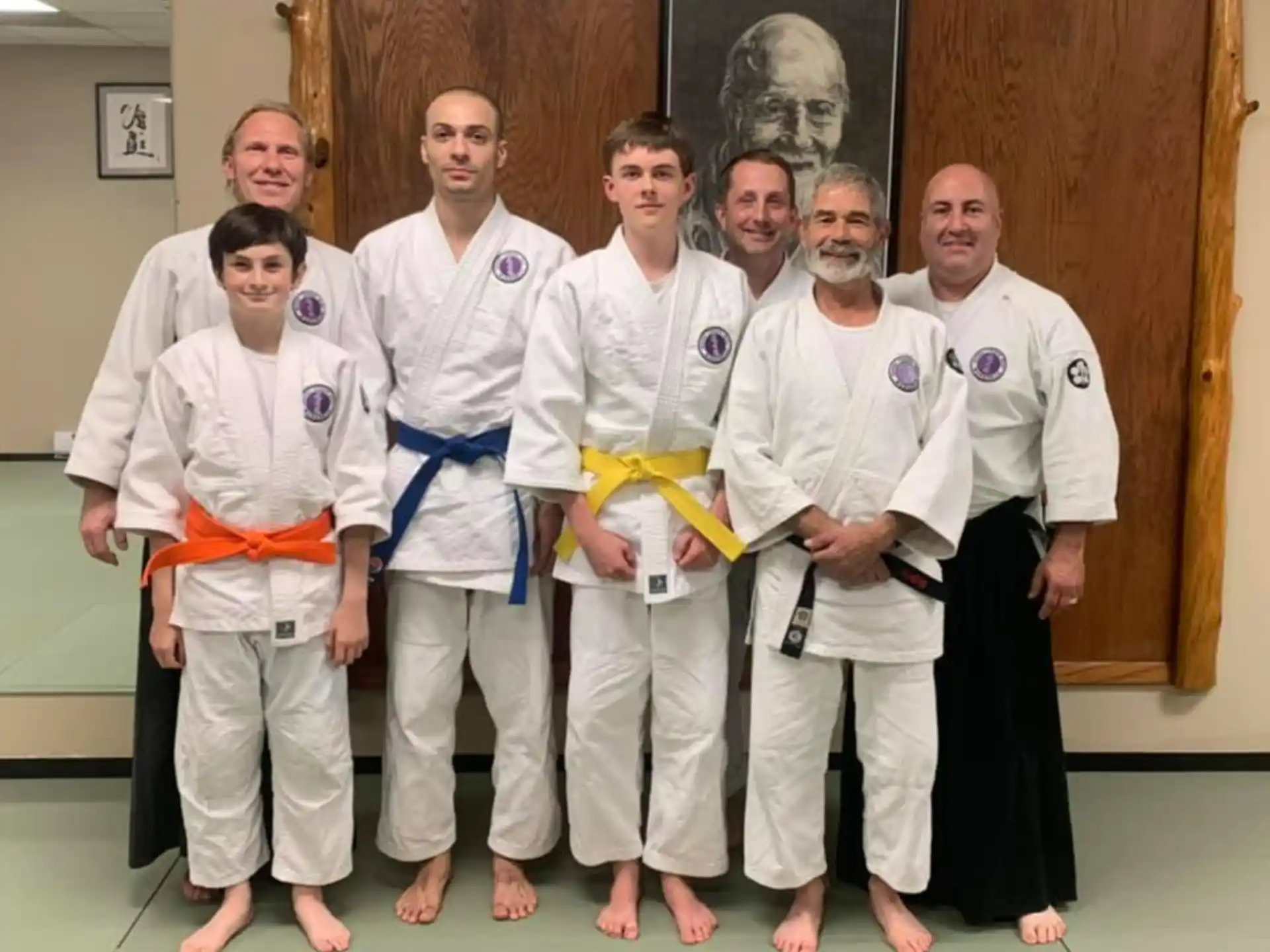 a group of people wearing white karate uniforms