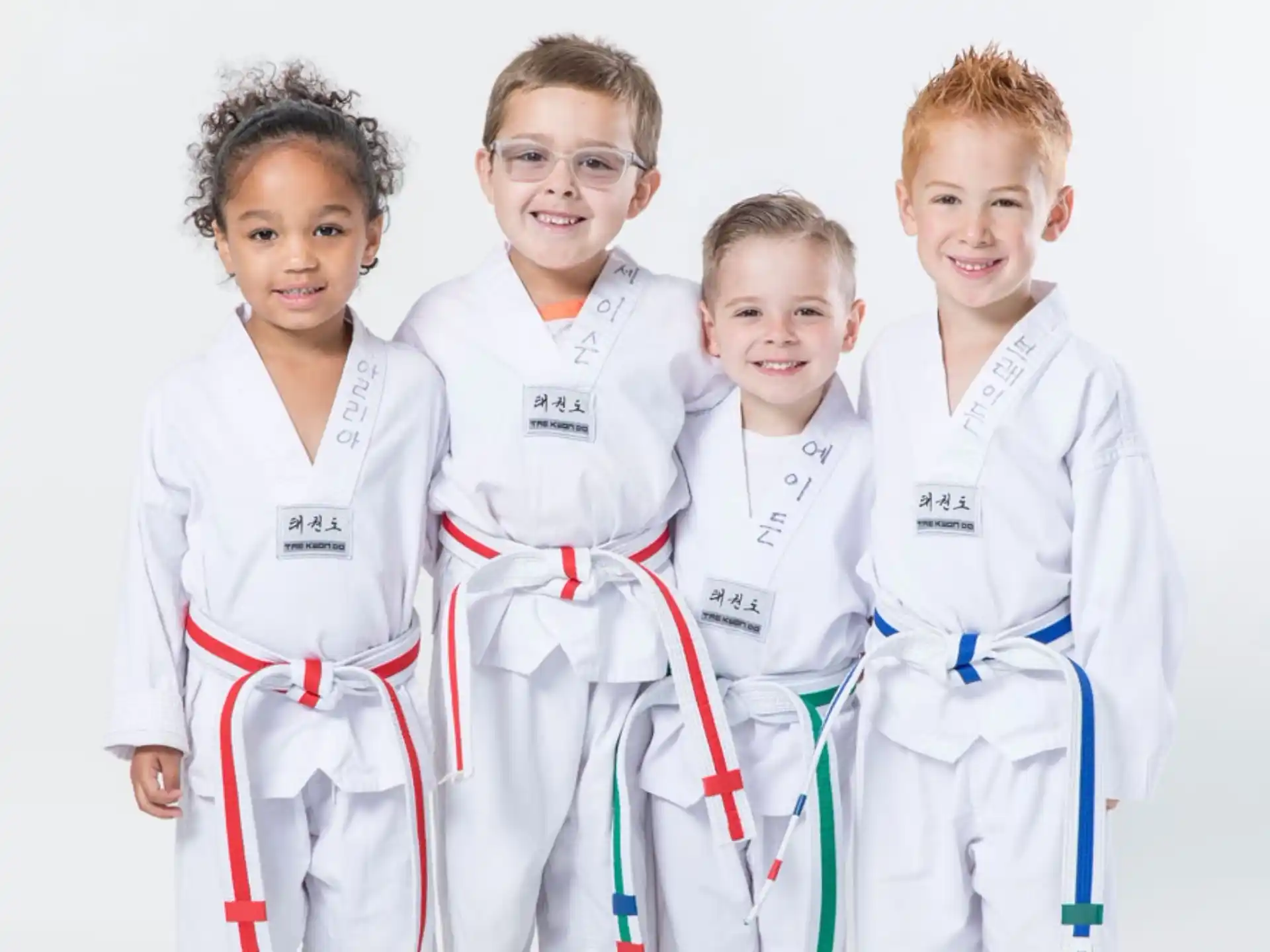a group of boys in white karate uniforms