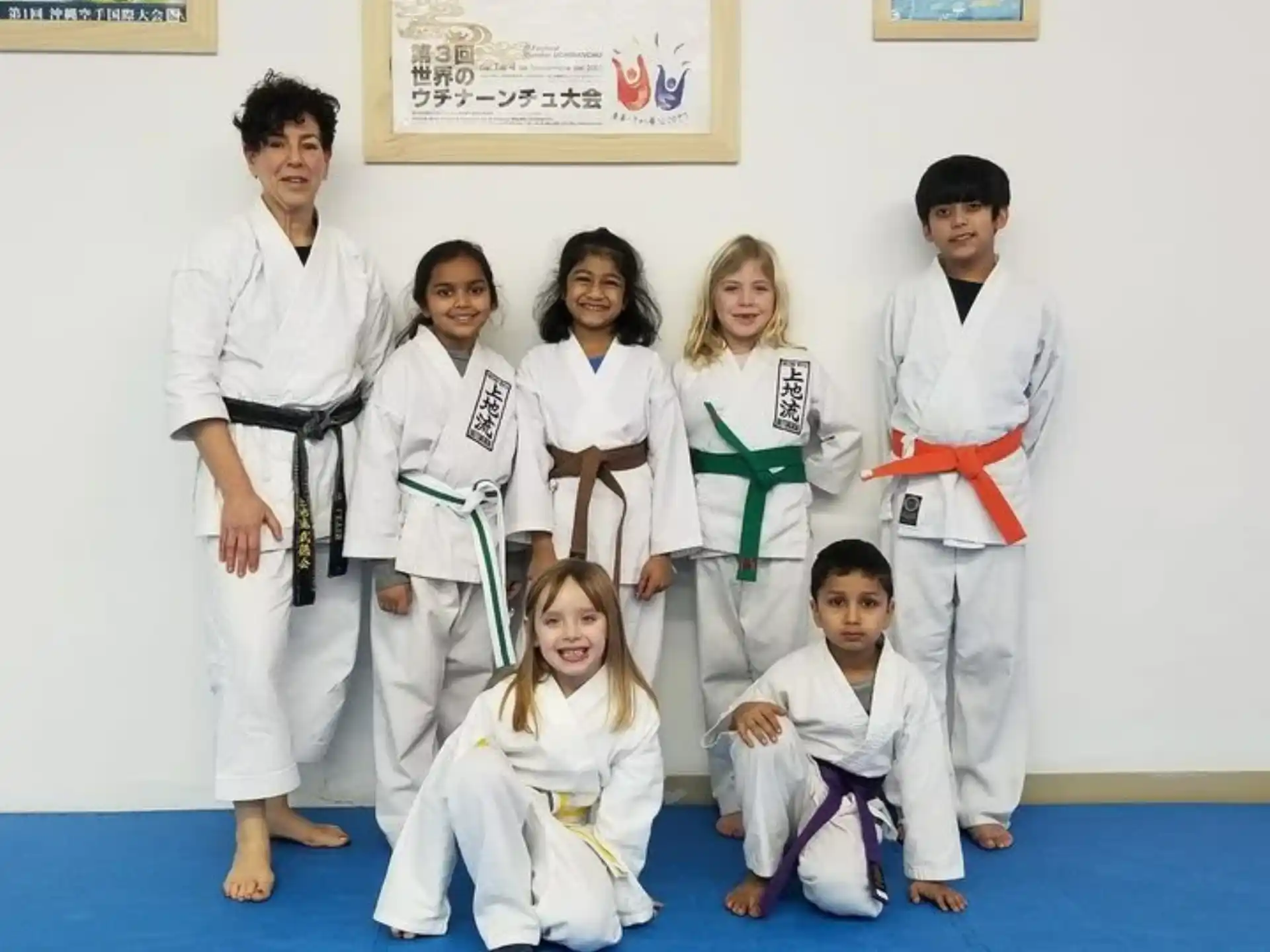 a group of people in white karate uniforms