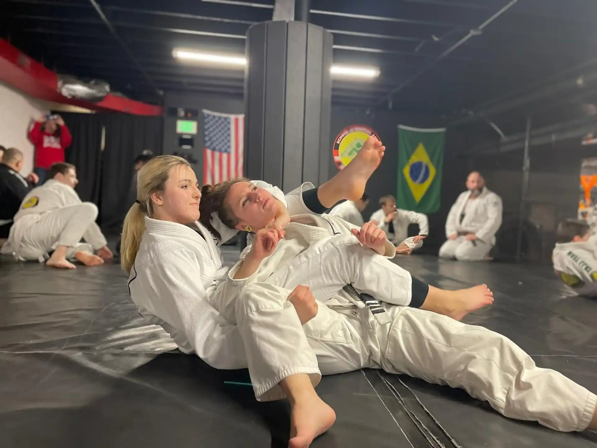a person lying on a person's back in a gym