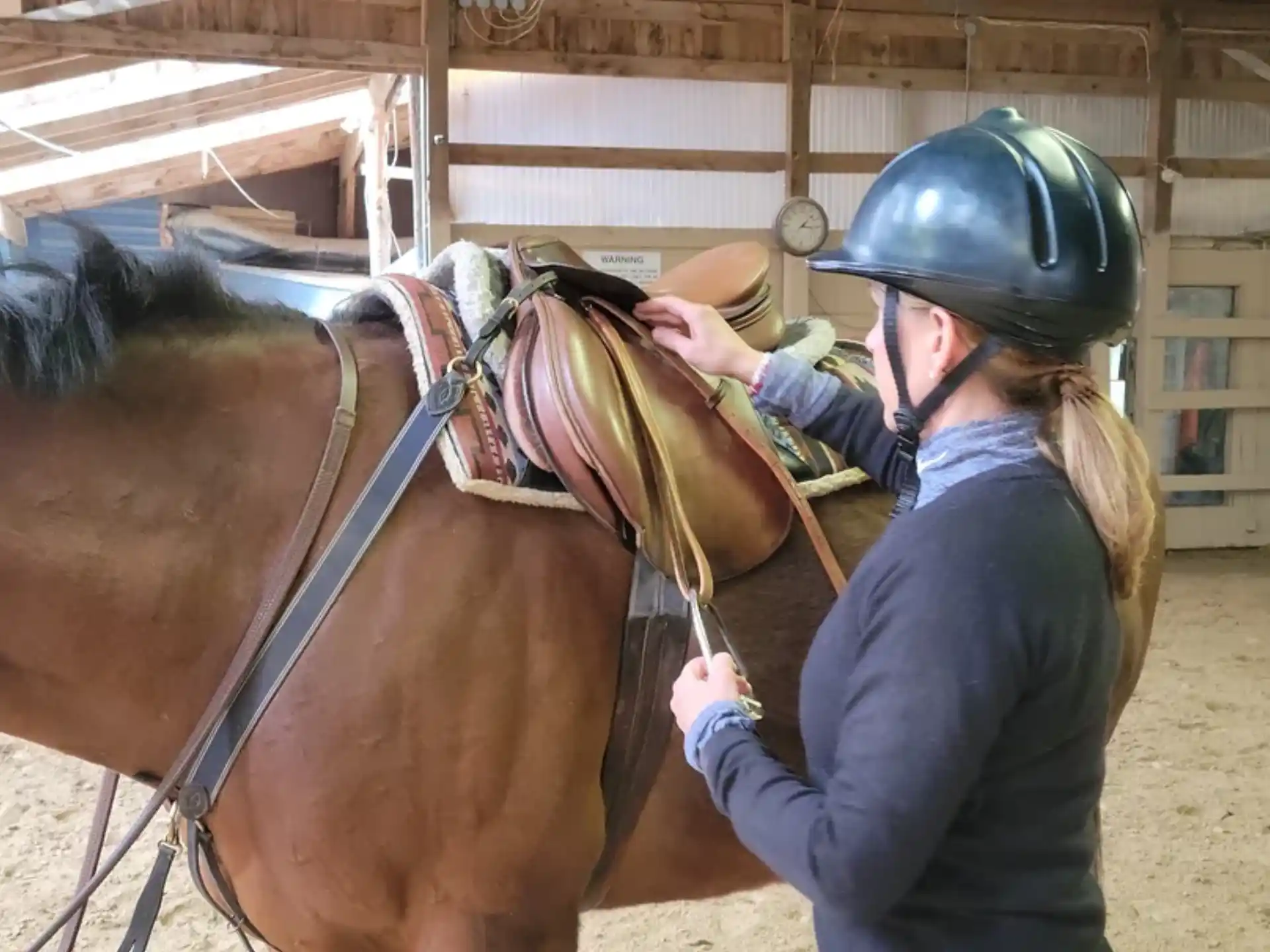 a person with a helmet on a horse