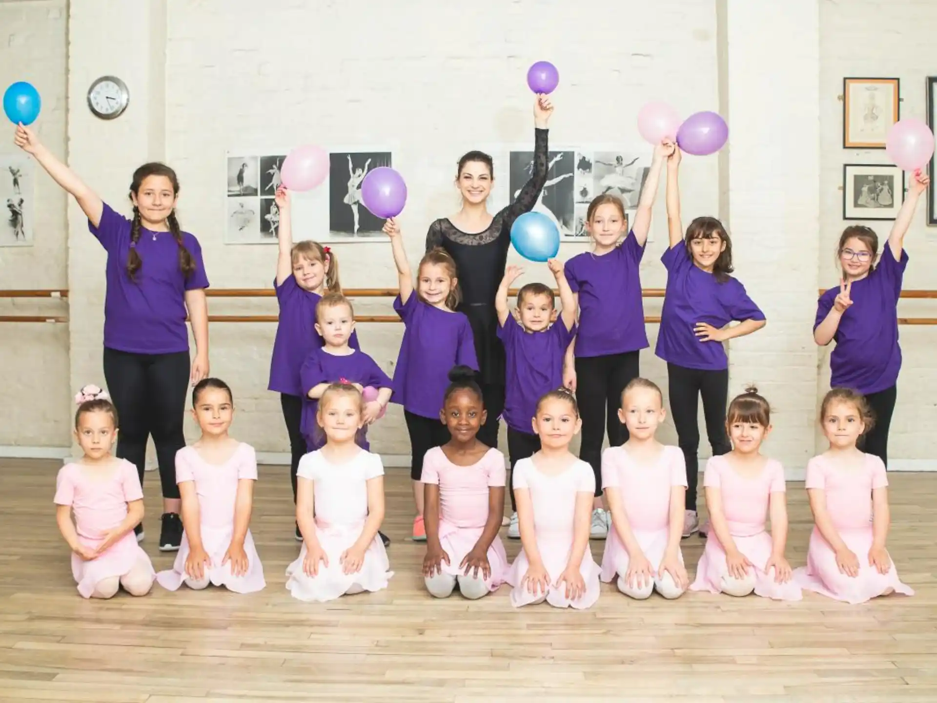 a group of people posing for a photo with balloons