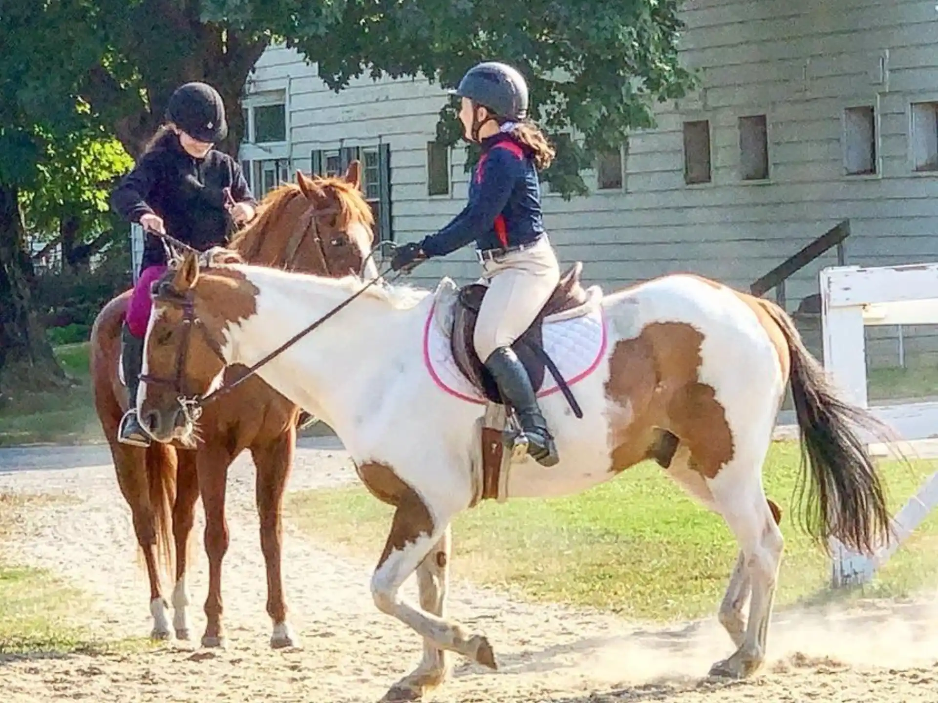 two girls riding horses