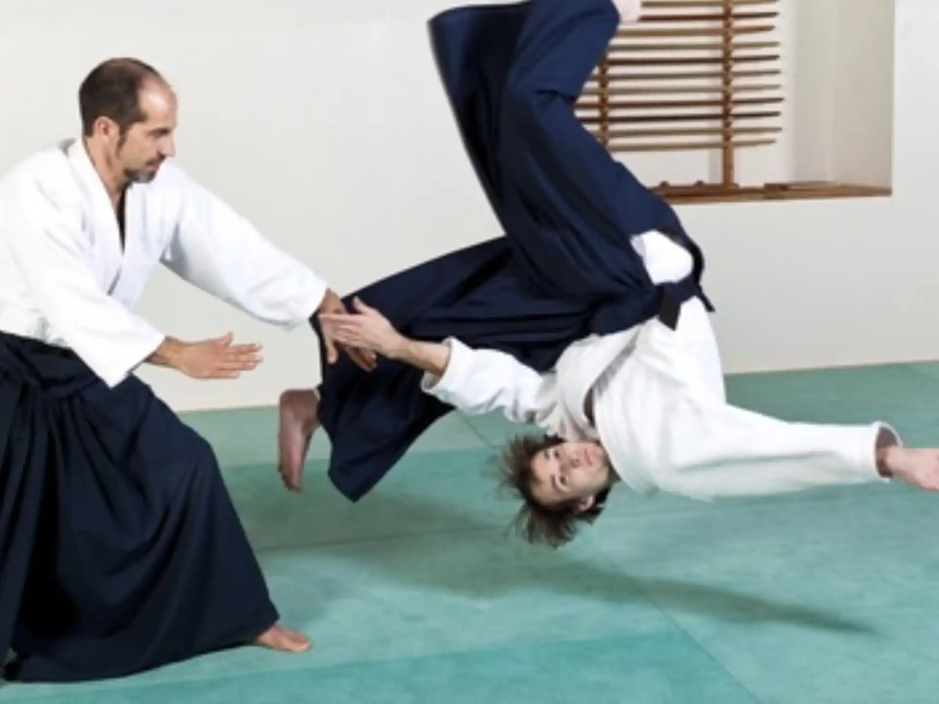 a person kicking another man in the face