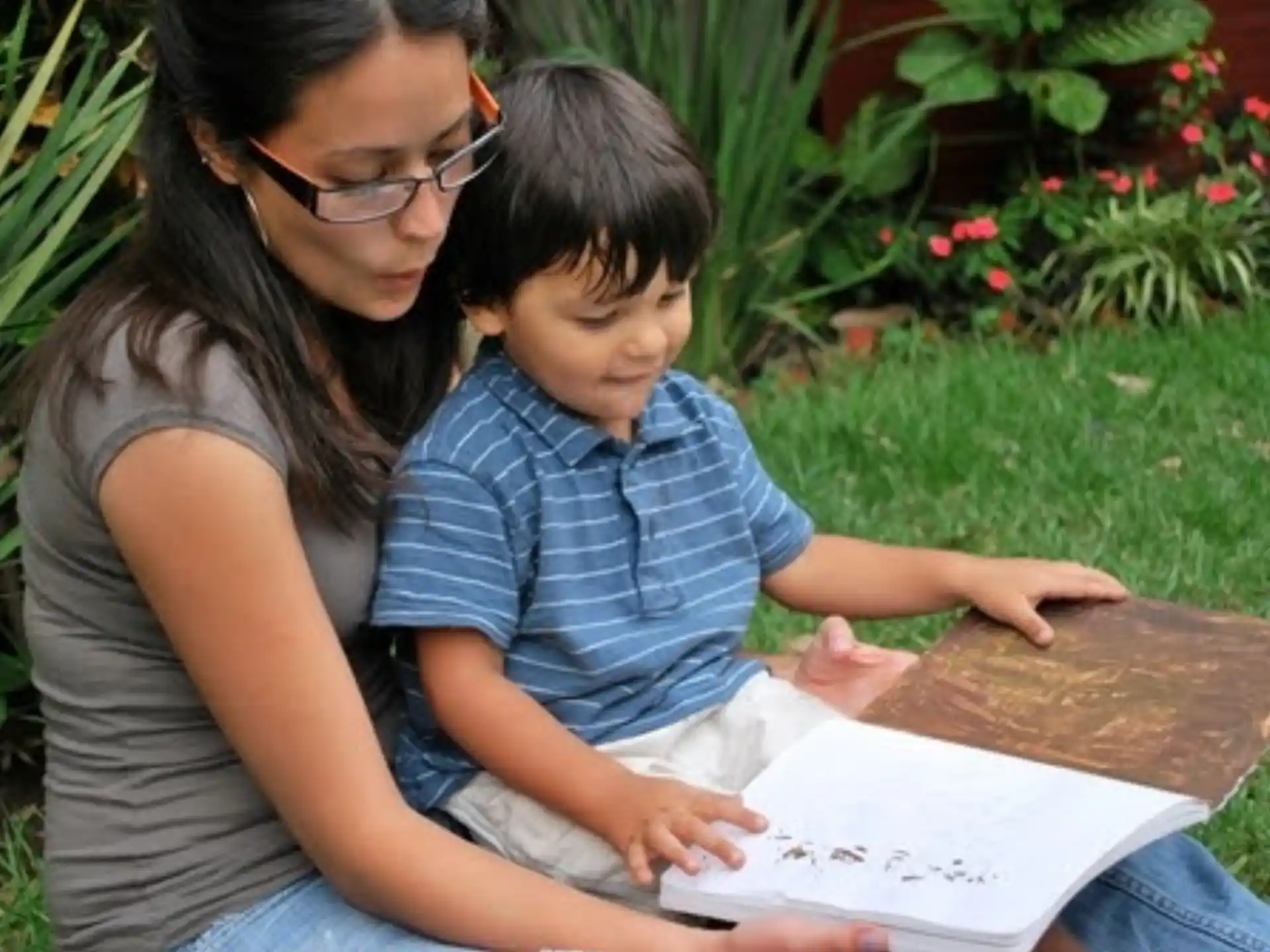 a person and a child looking at a book