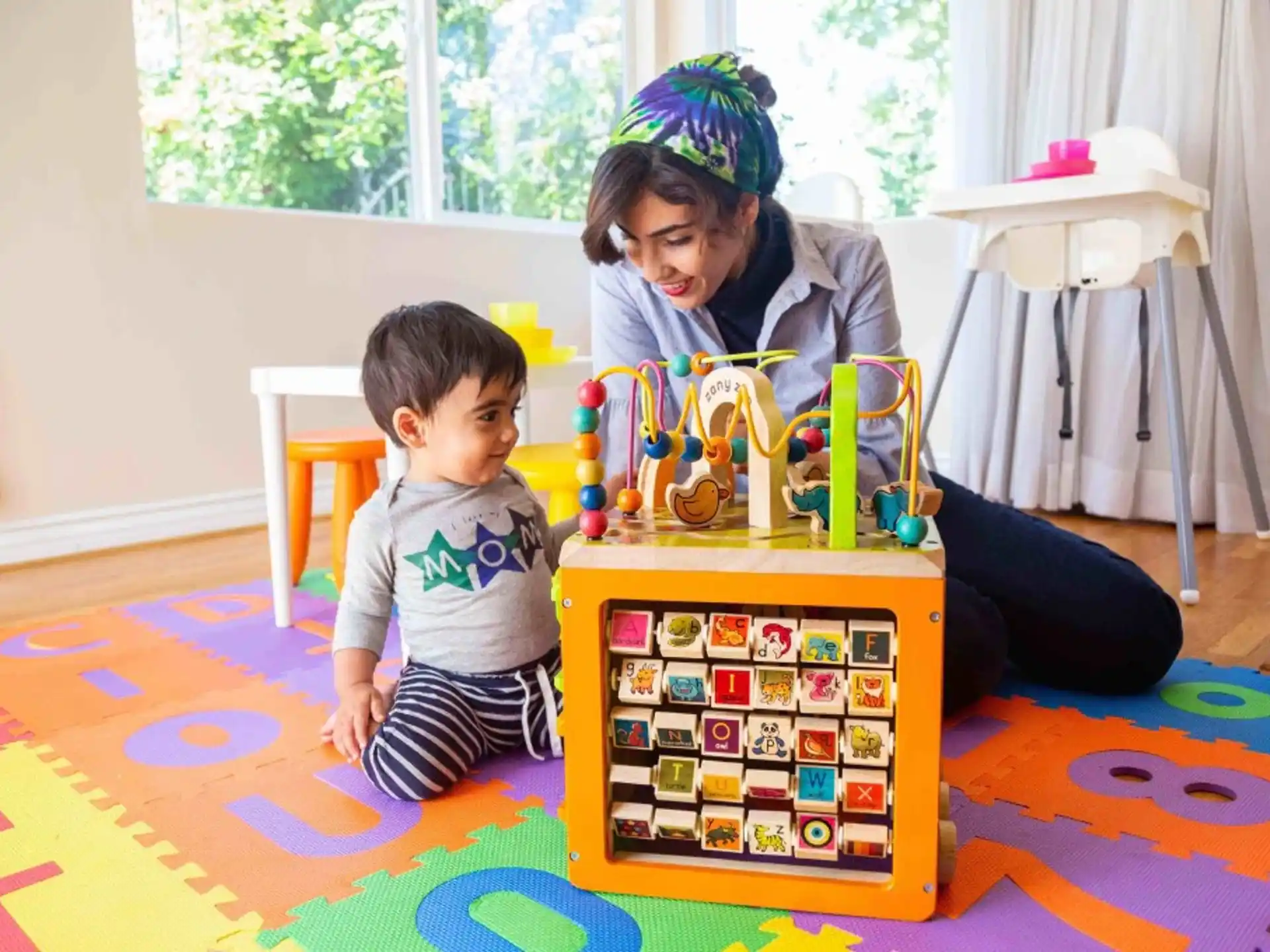 a person and a child playing with a toy