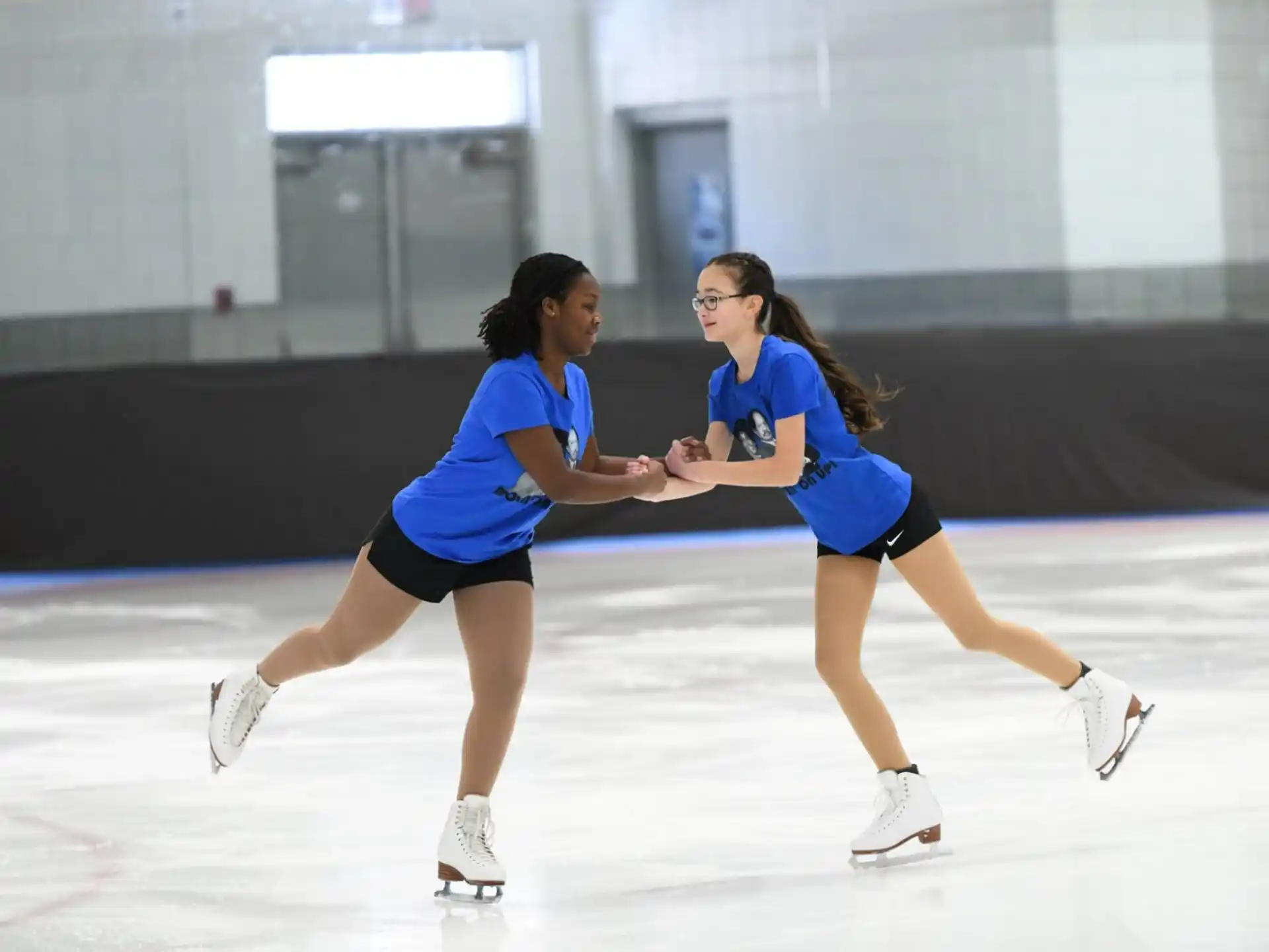 women ice skating on ice