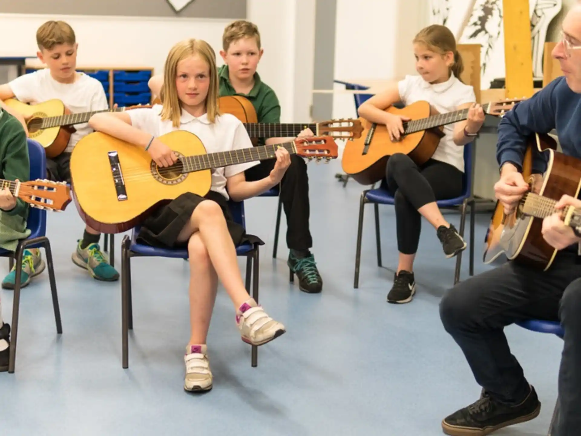 a group of people playing guitars