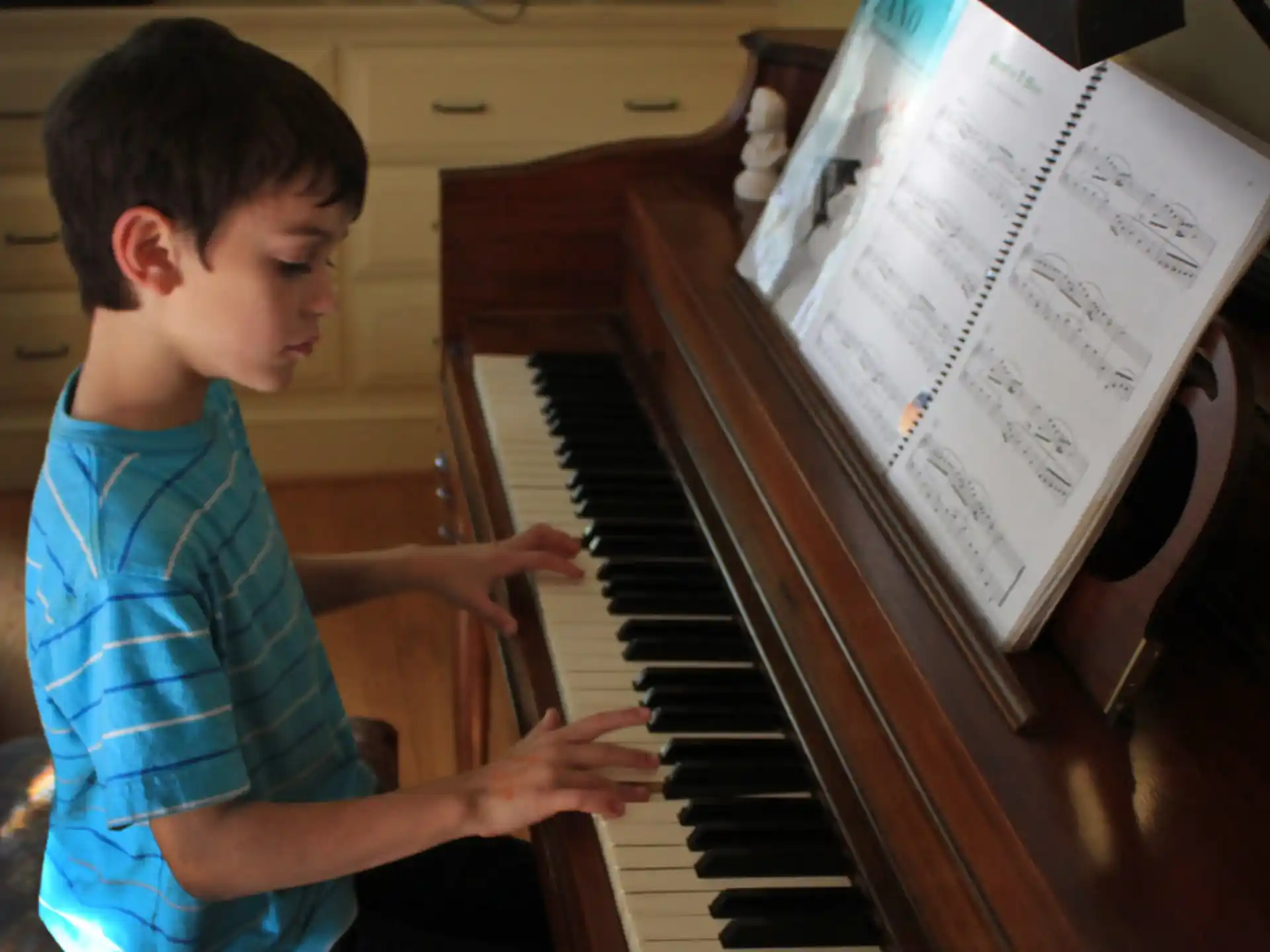 a boy playing a piano
