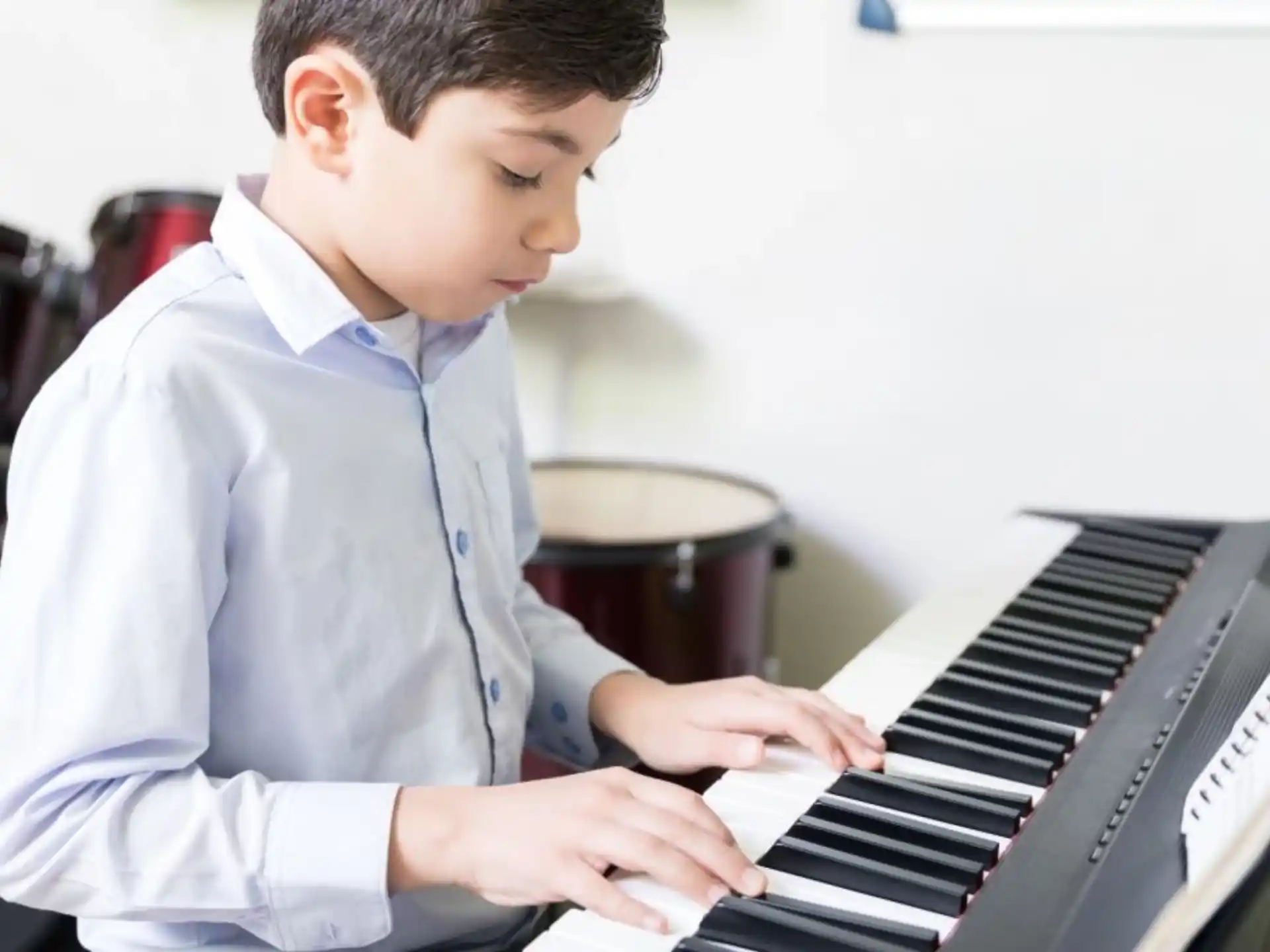 a boy playing a piano