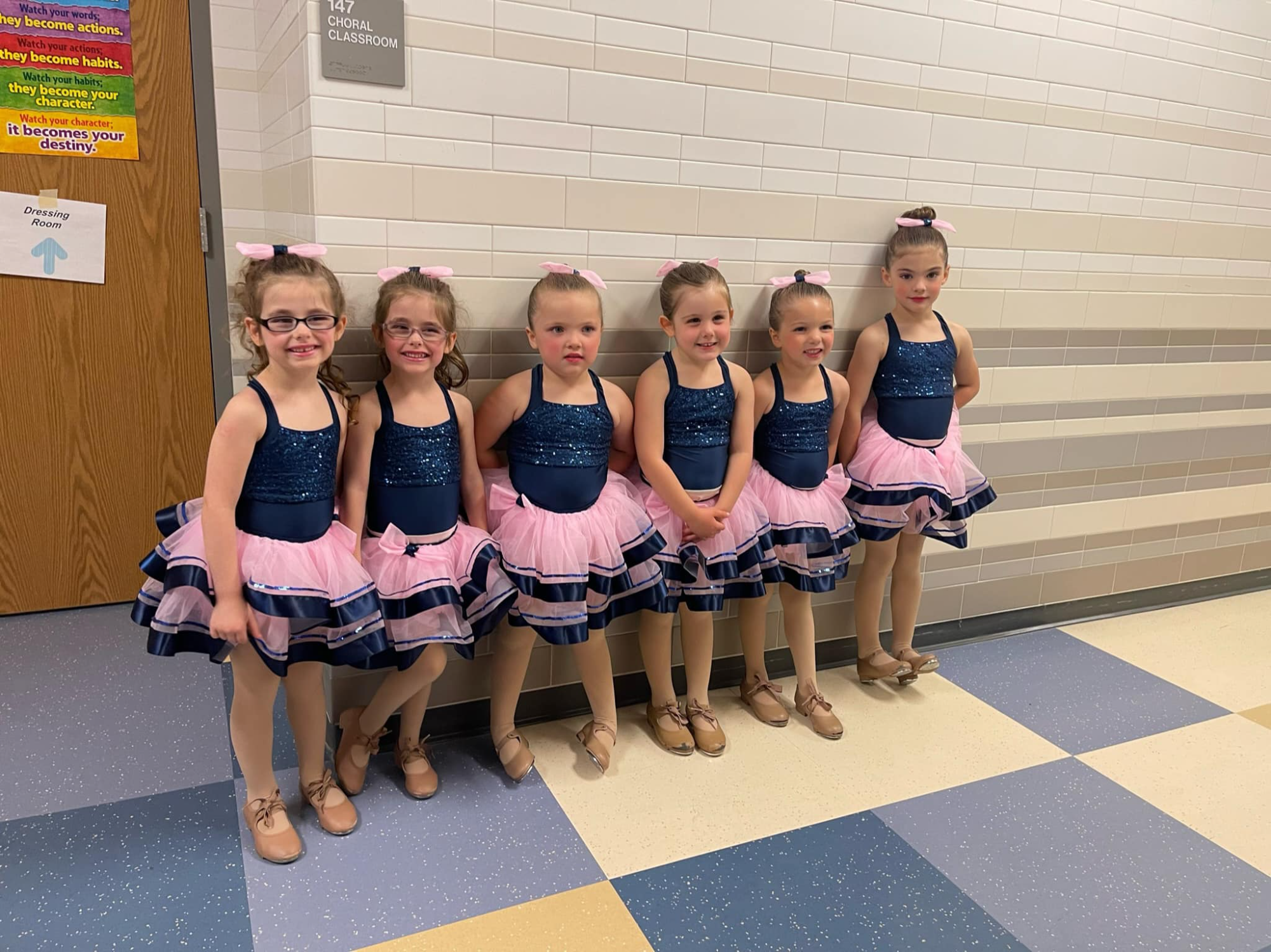 a group of girls in matching outfits