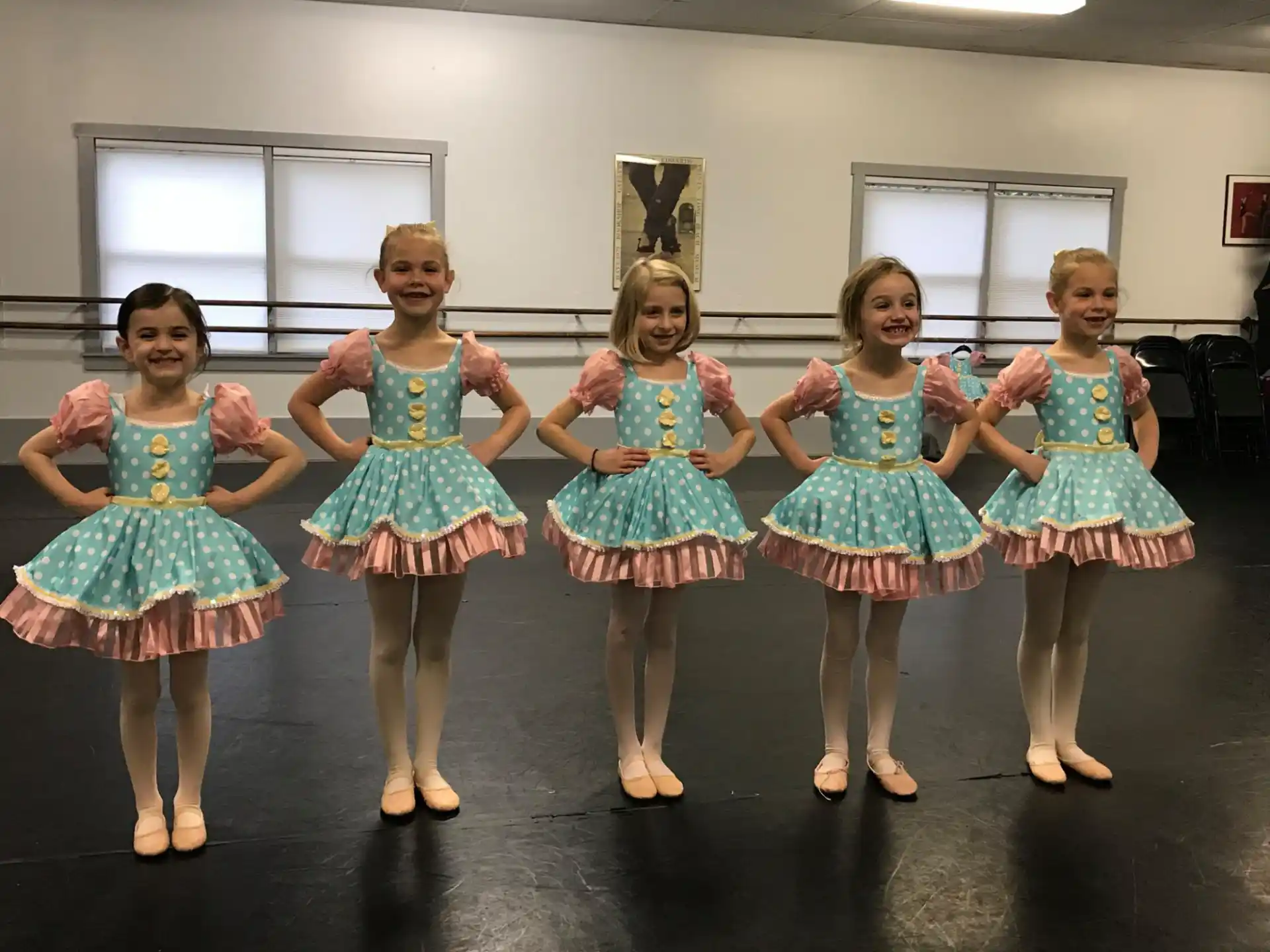 a group of girls in dresses