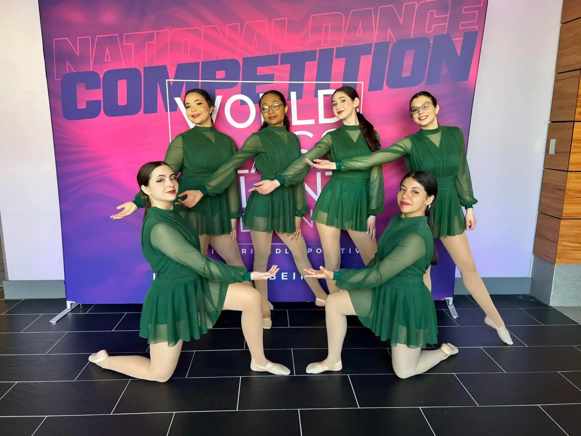 a group of people in green dresses