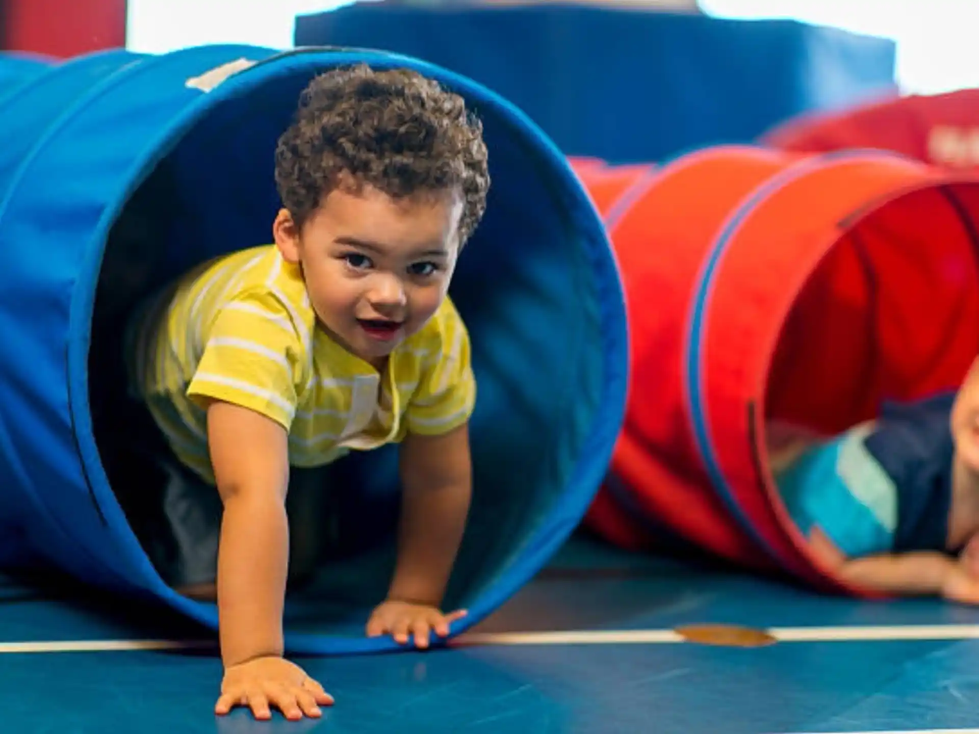 a young boy playing on a trampoline