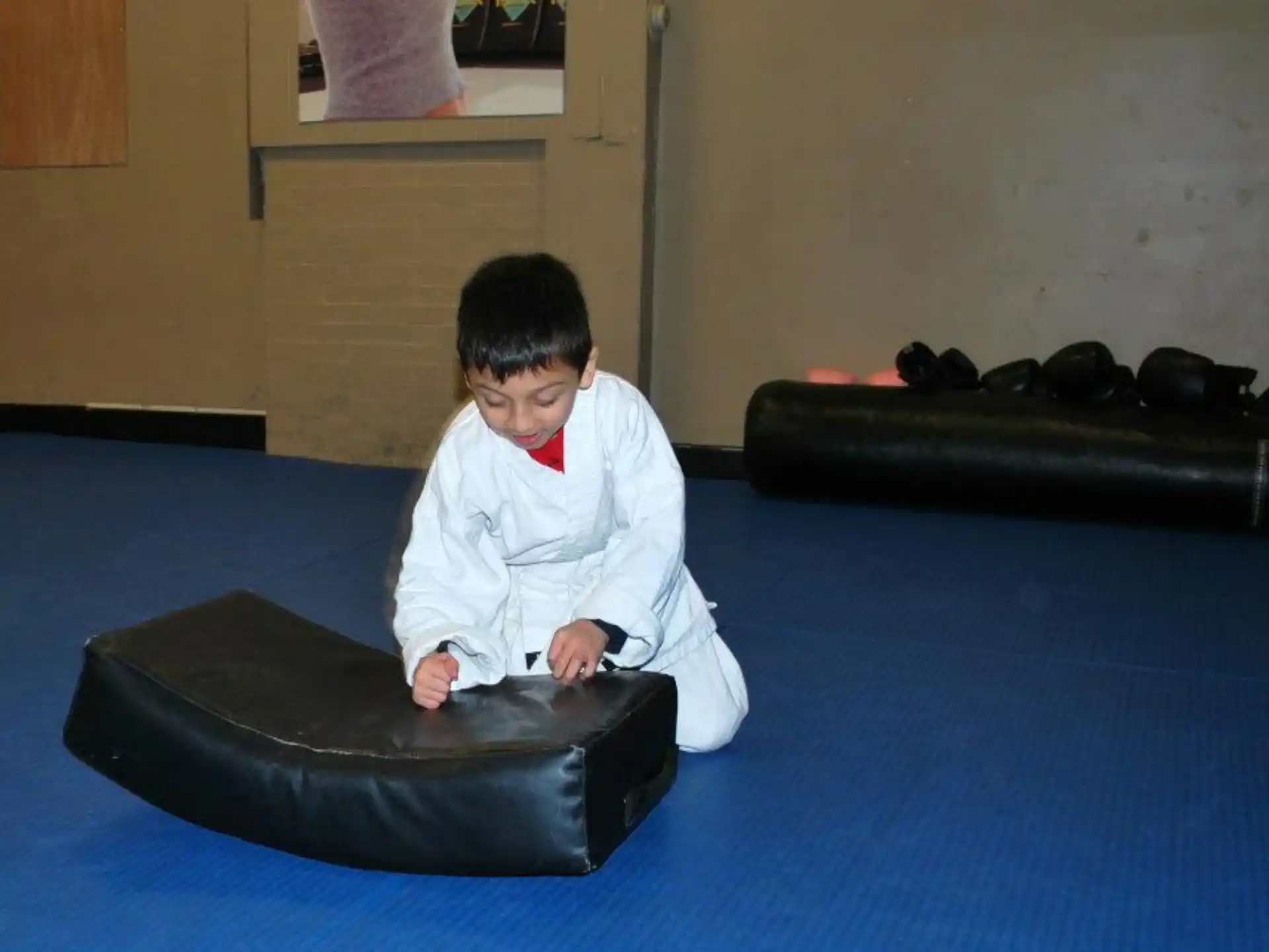 a boy sitting on a mat
