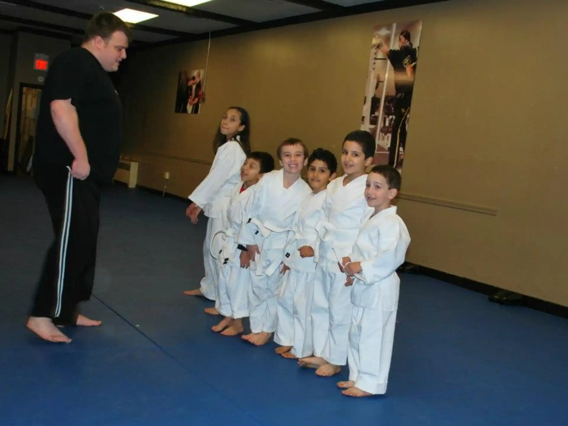 a group of children in karate uniforms