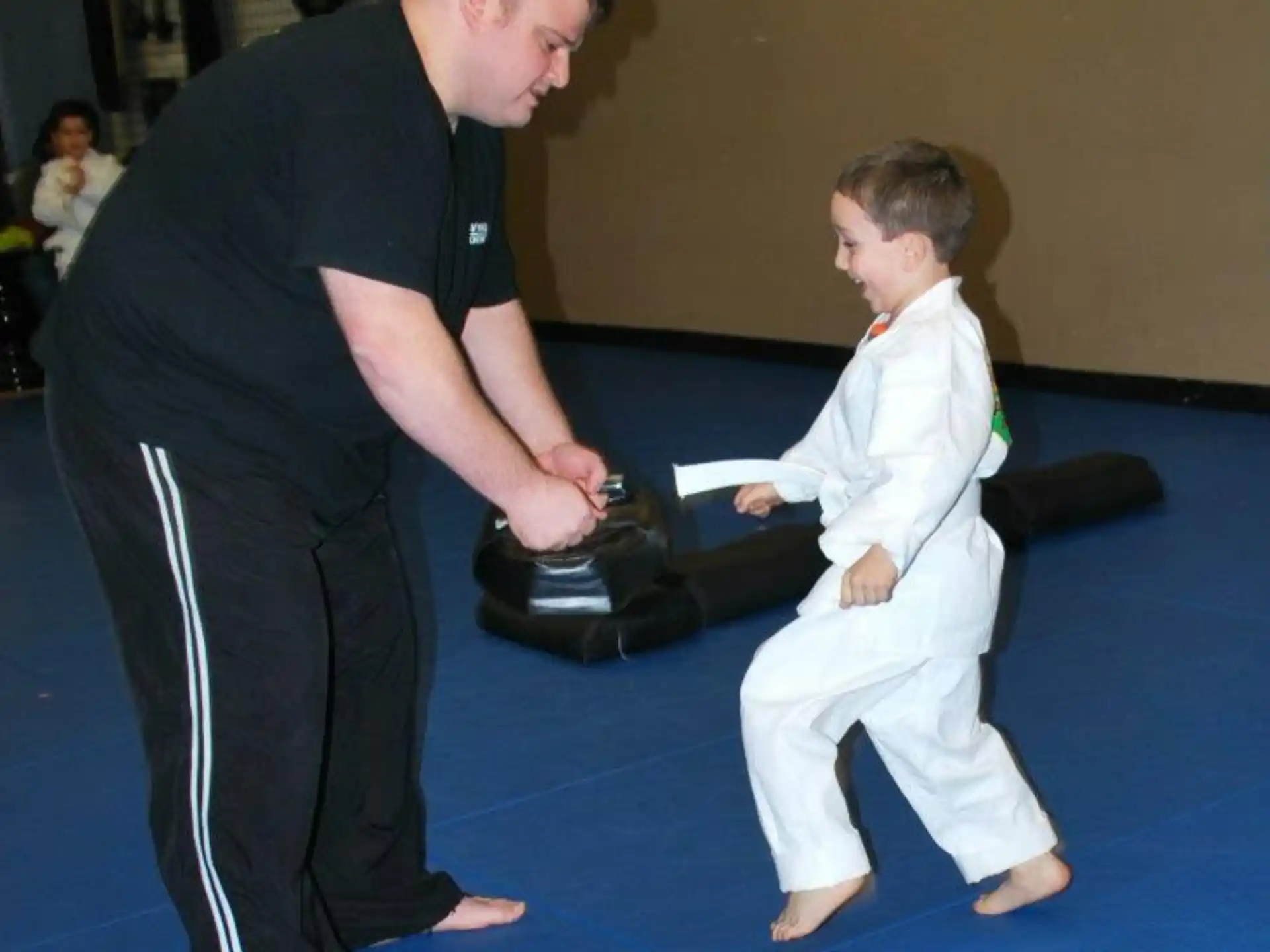 a person and a boy in karate uniforms