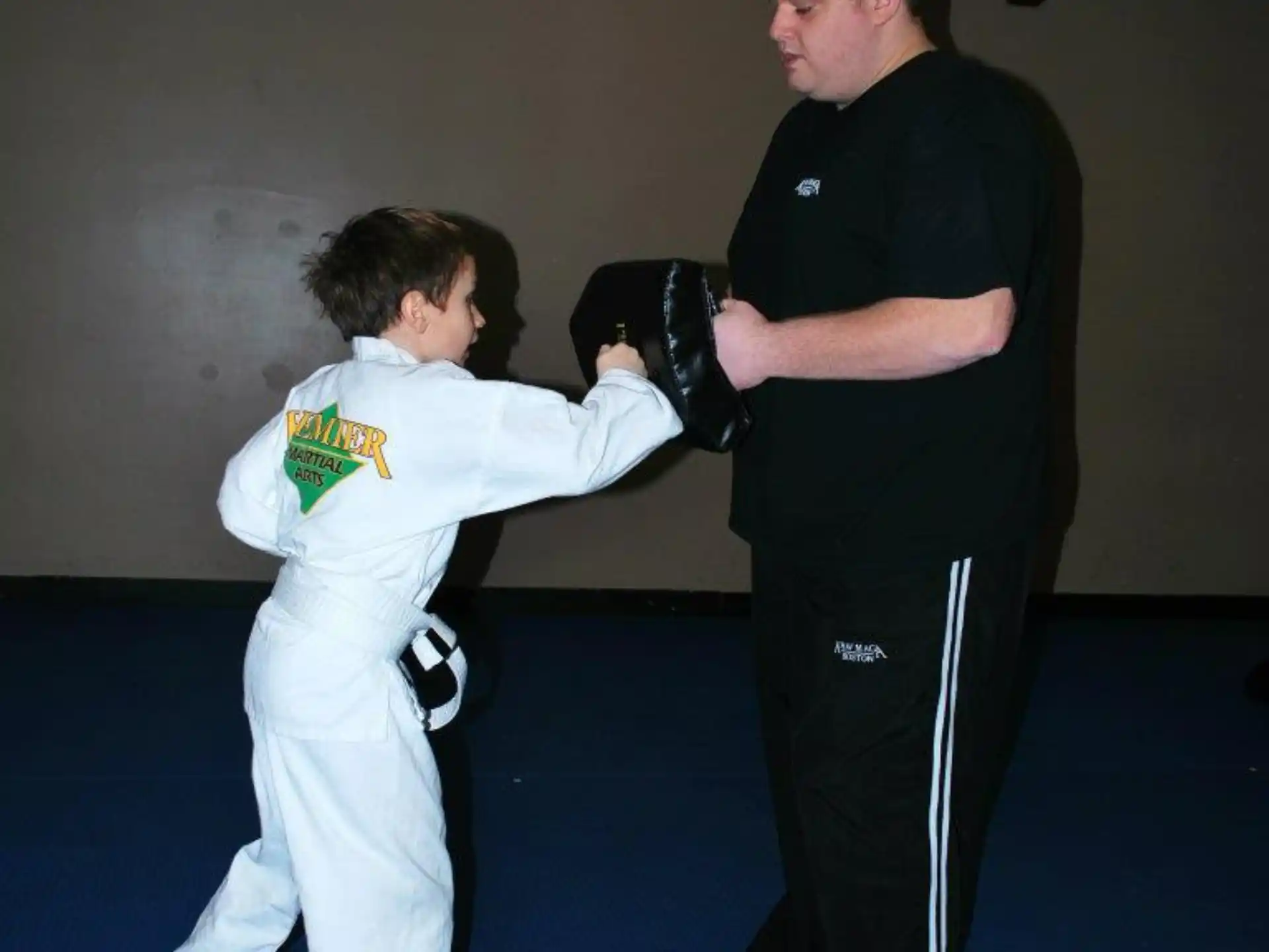 a person taking a picture of a person in a martial arts uniform