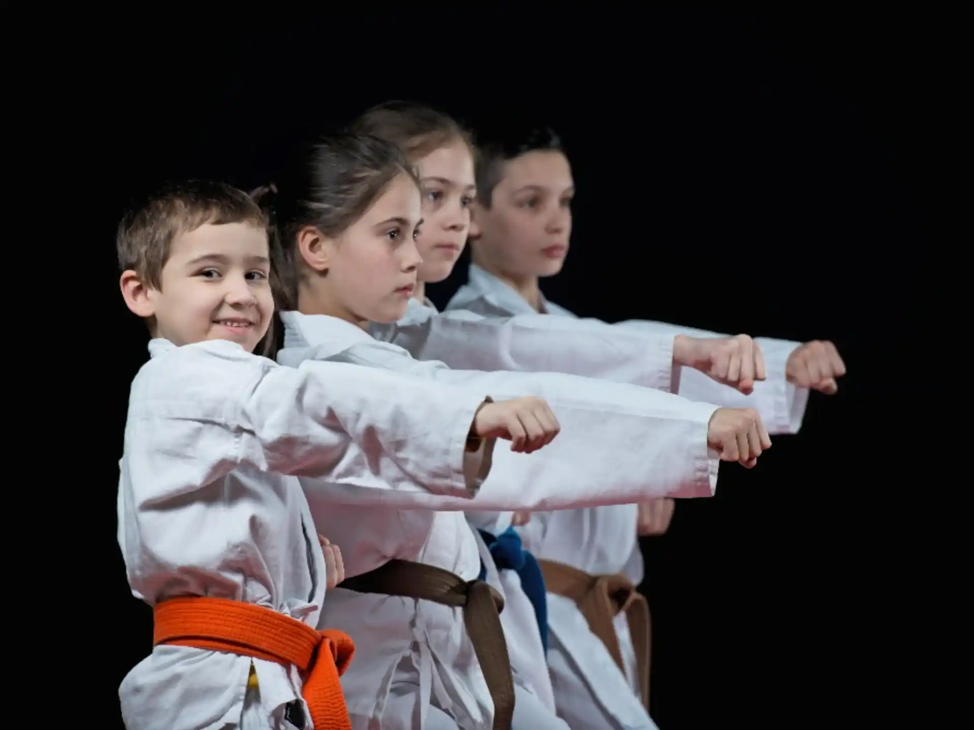 a group of boys in karate uniforms