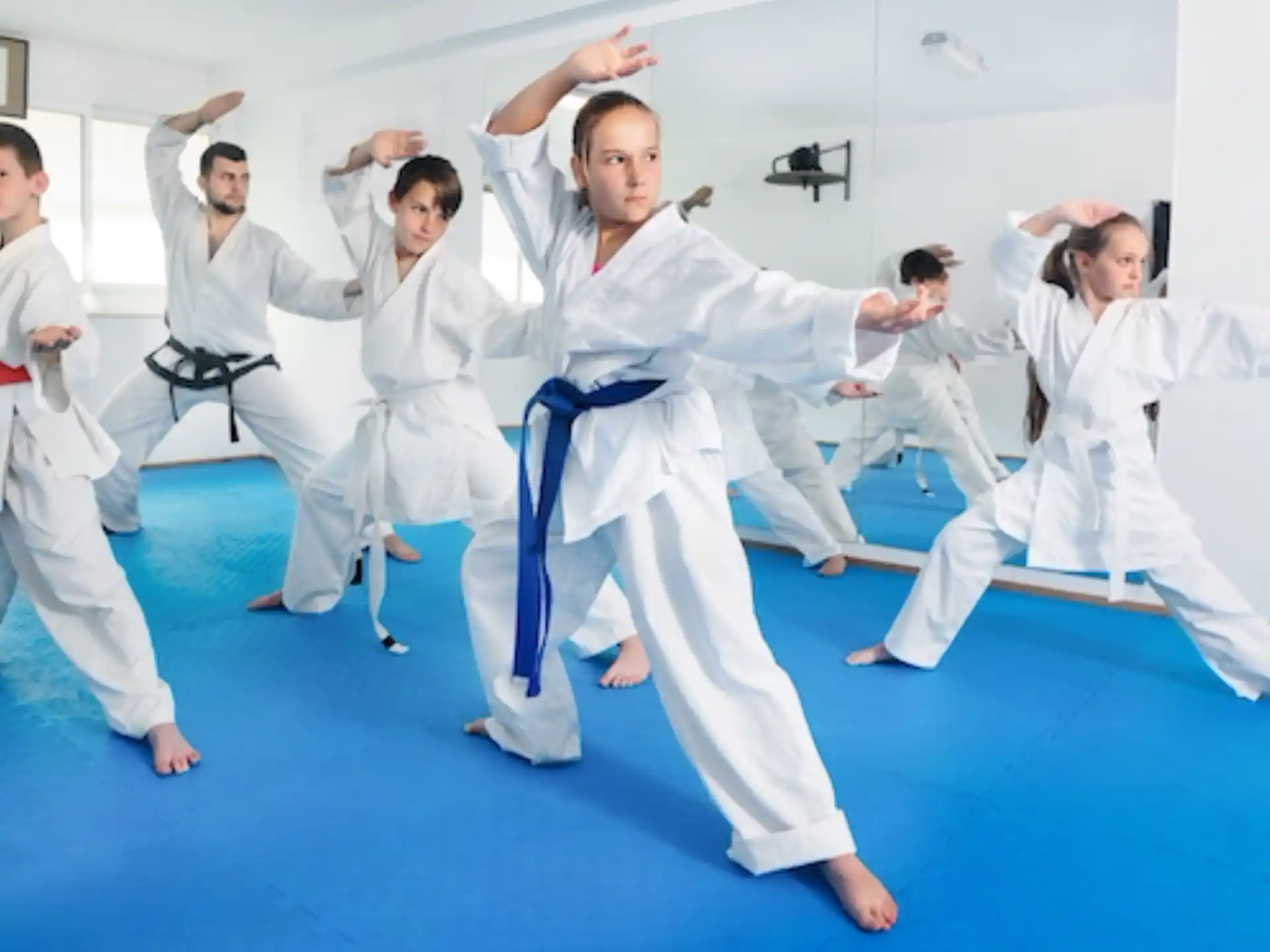 a group of people in white karate uniforms