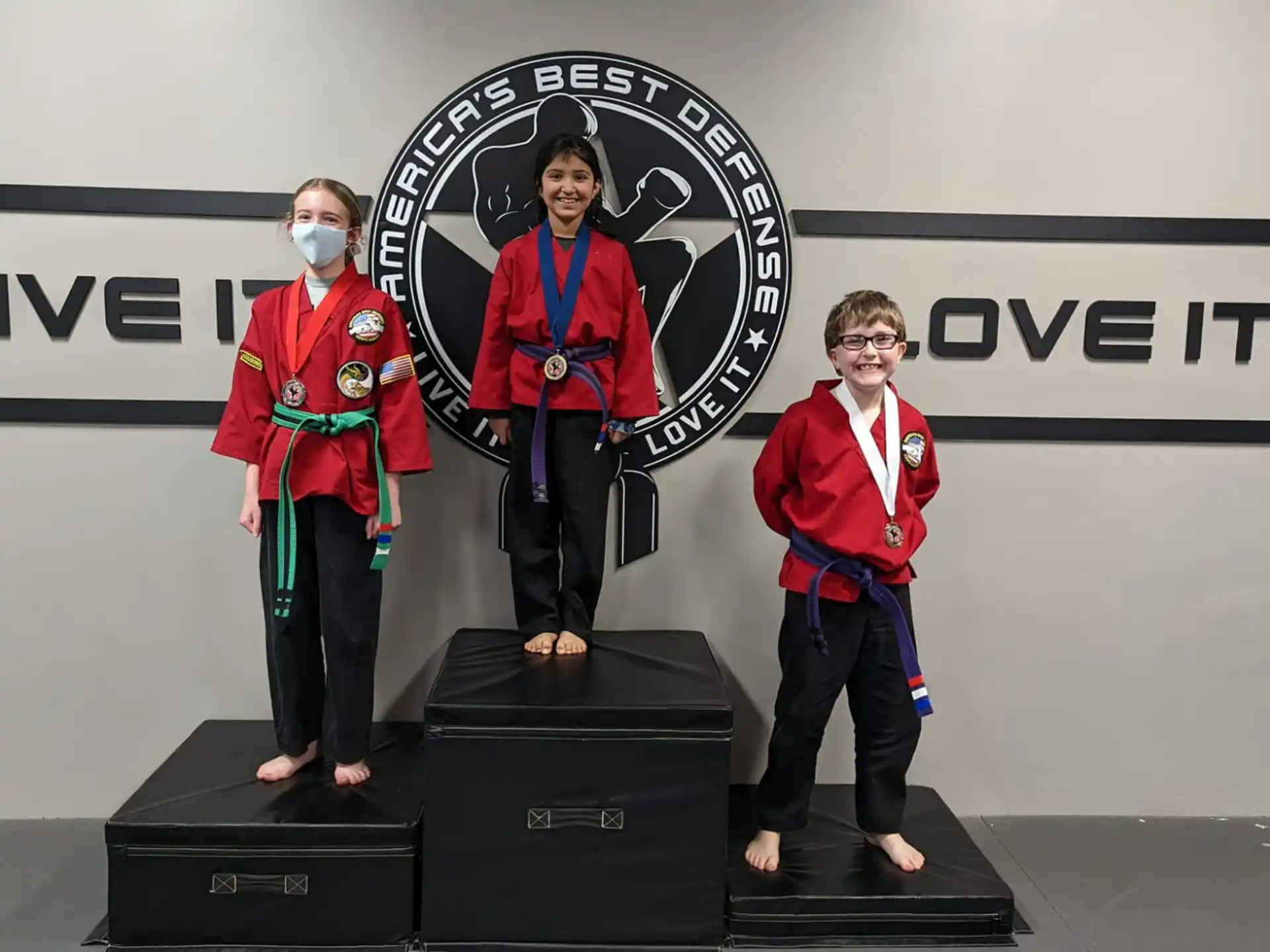 a group of people wearing medals and standing on a podium