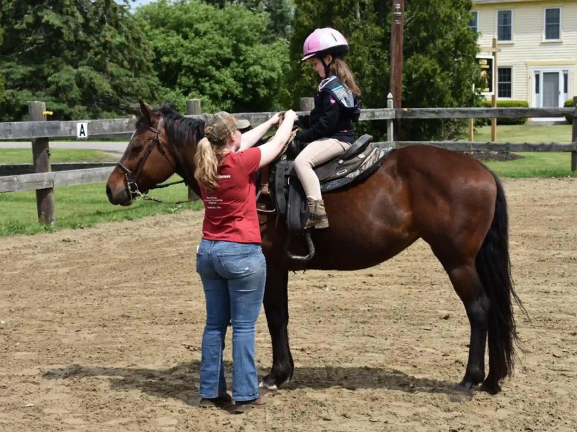 a person leading a girl on a horse