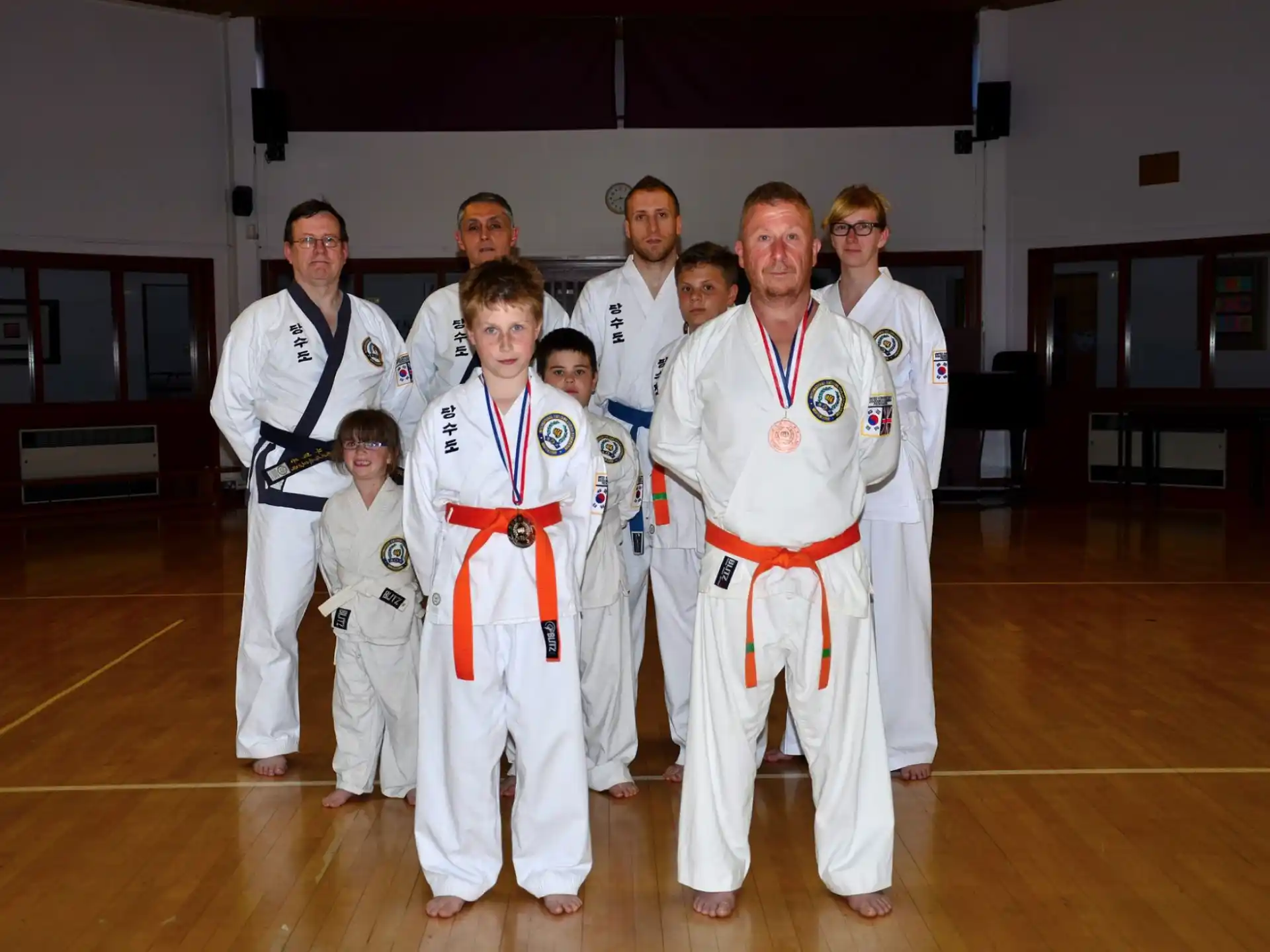 a group of people in karate uniforms