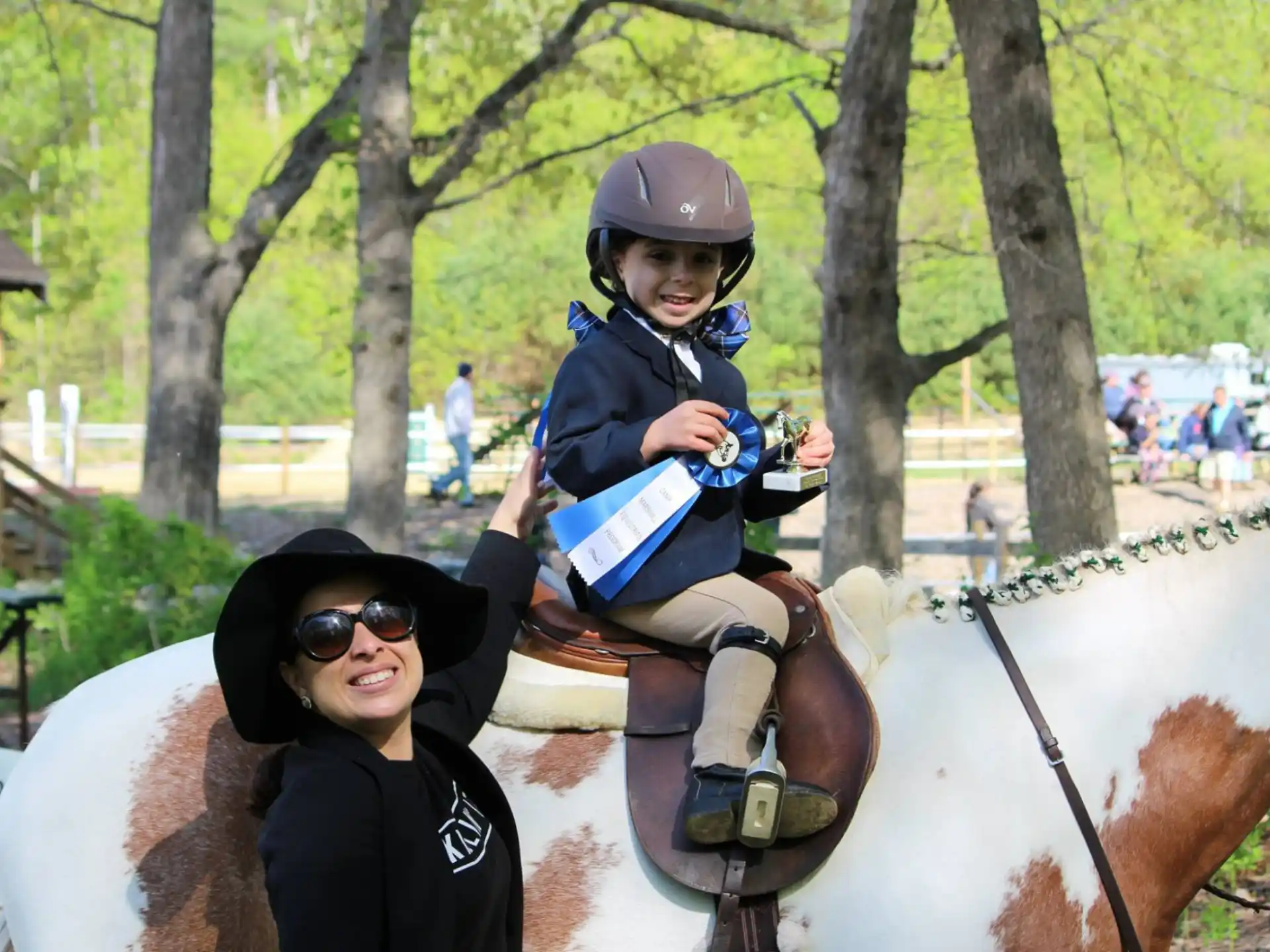 a person and a child riding a horse