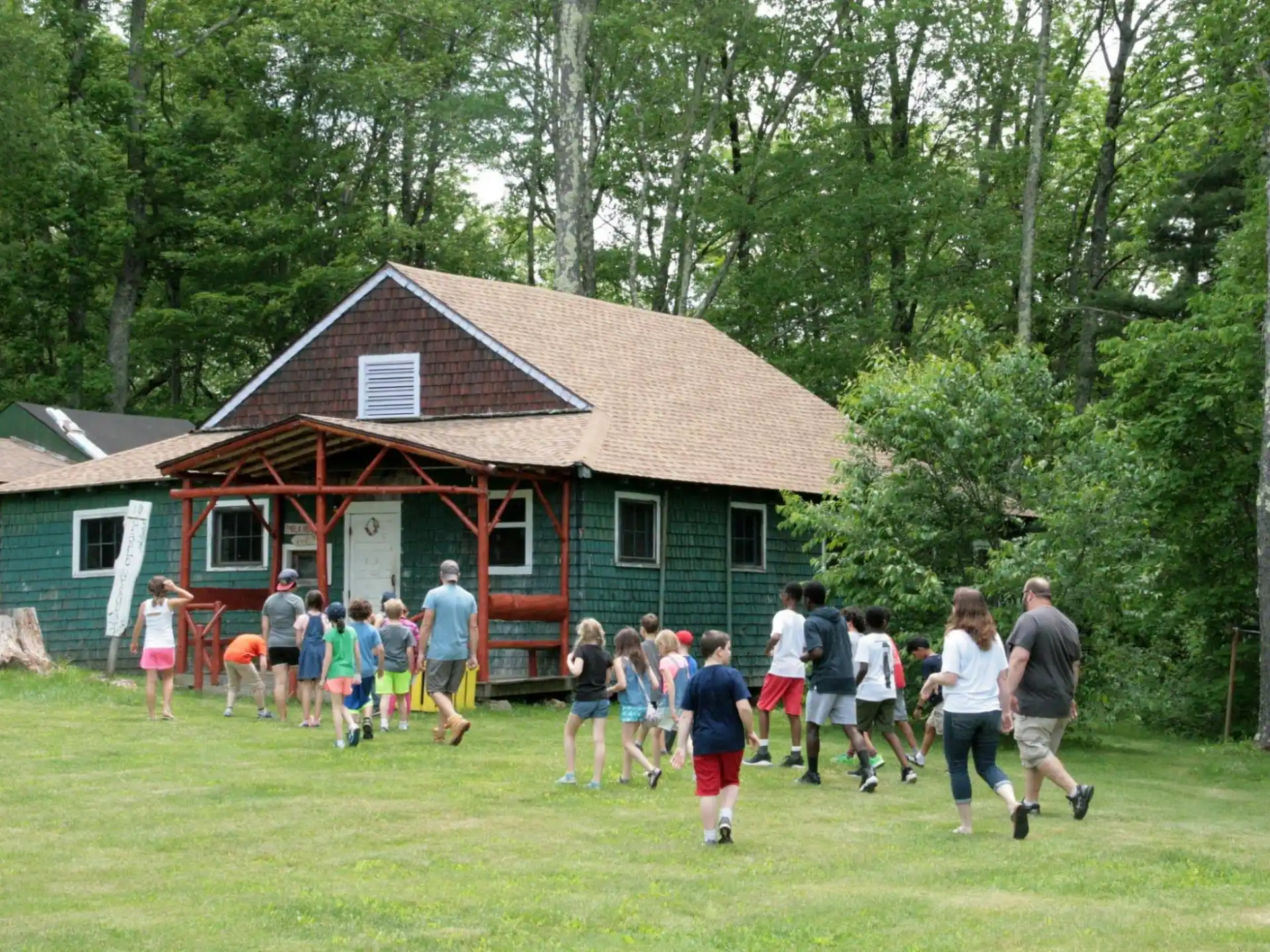 a group of people walking in front of a house