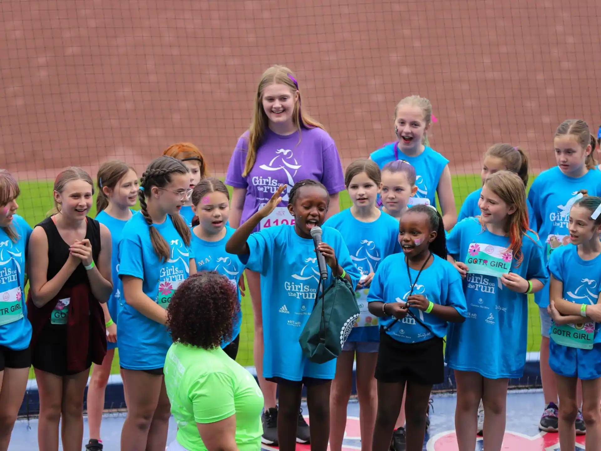 a group of people in matching blue shirts