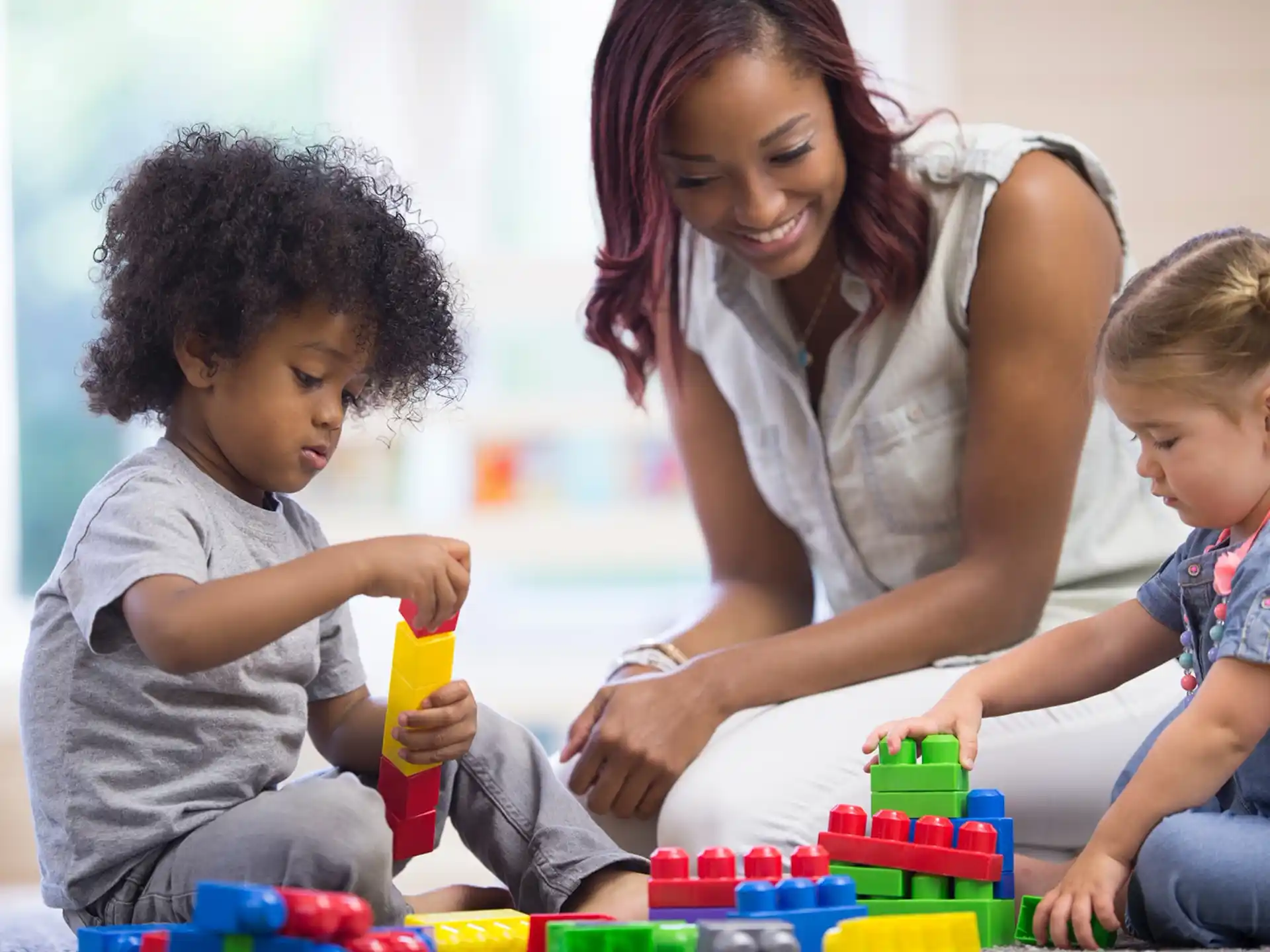 a person and children playing with a toy