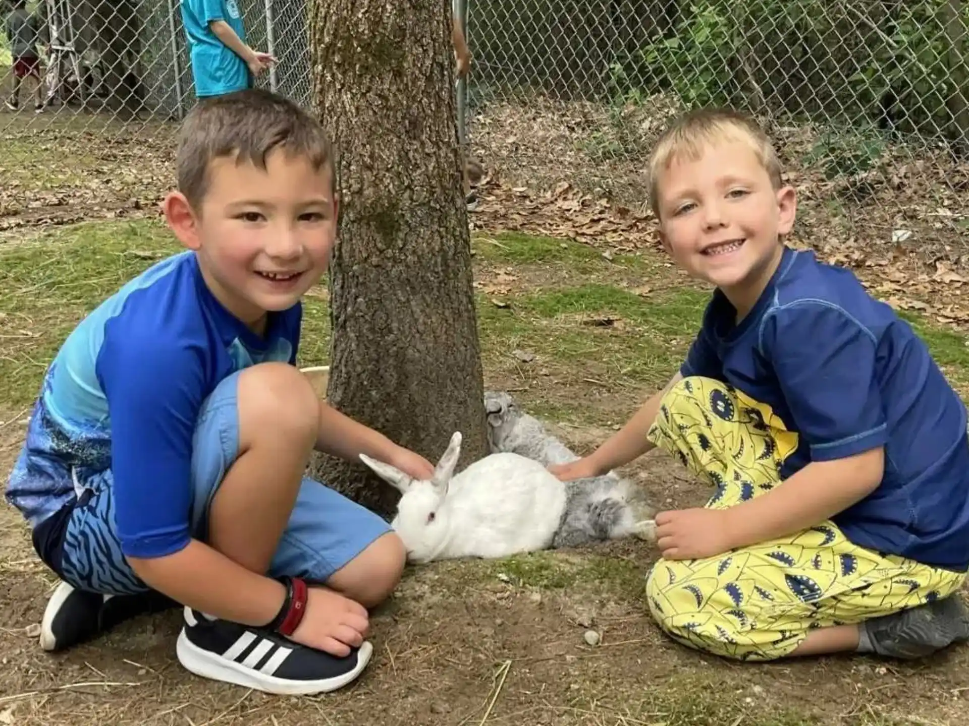 two boys sitting on the ground