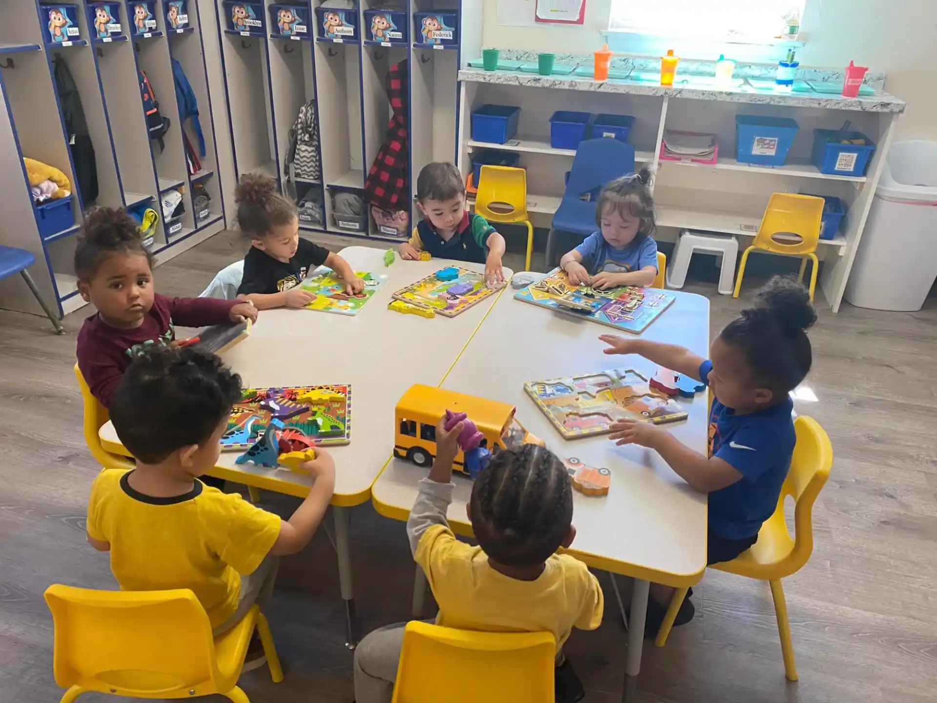 a group of children sitting around a table
