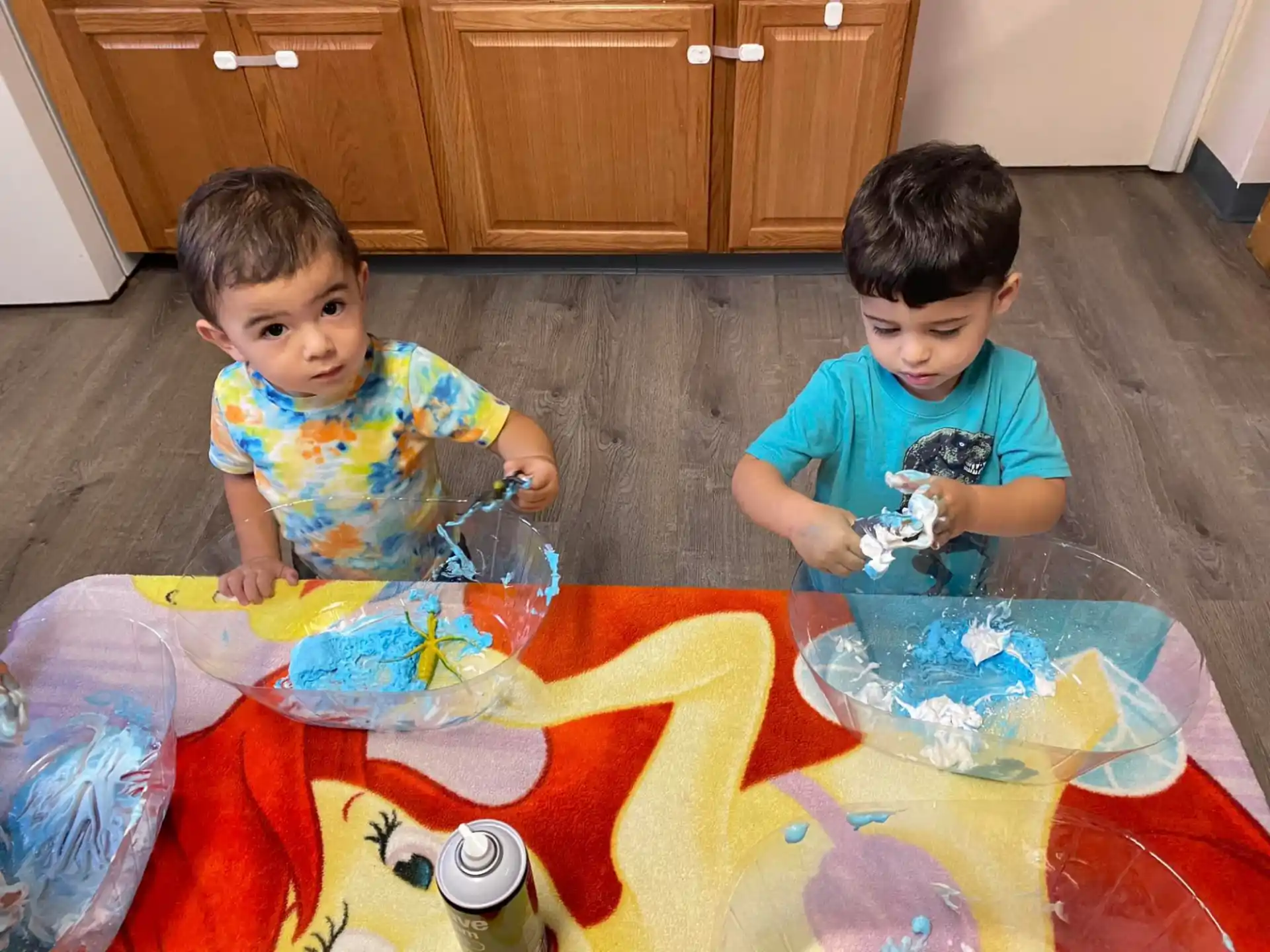 two boys sitting on the floor