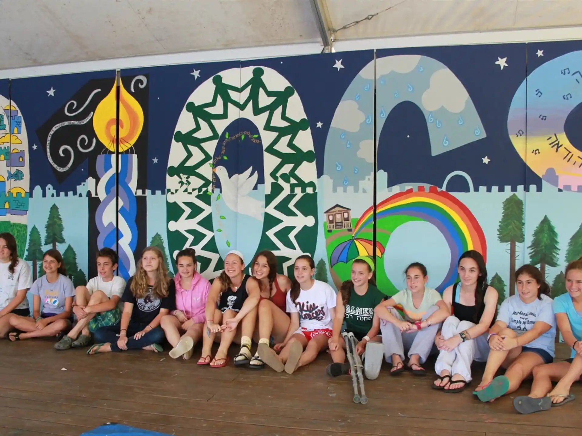 a group of people posing for a photo in front of a wall