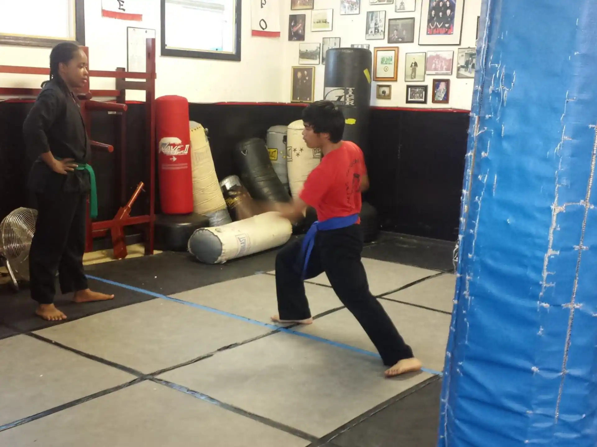 a boy kicking a blue rope