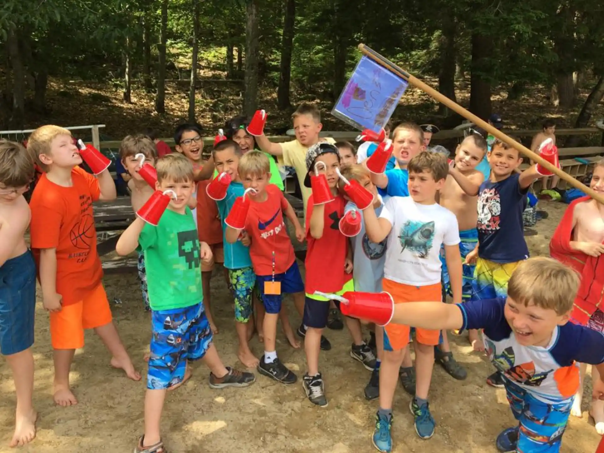 a group of children holding red and blue objects