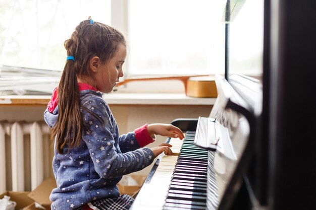 a girl playing a piano