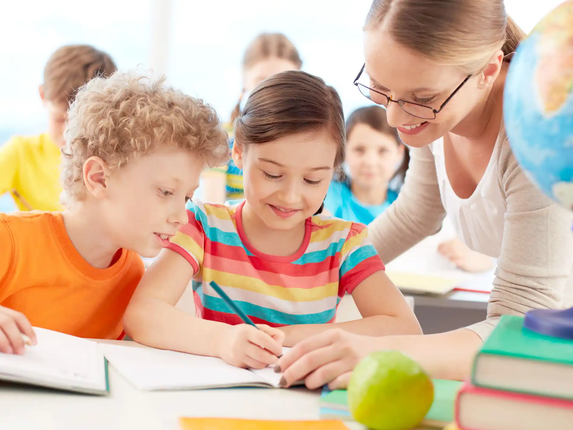 a person and children looking at a book