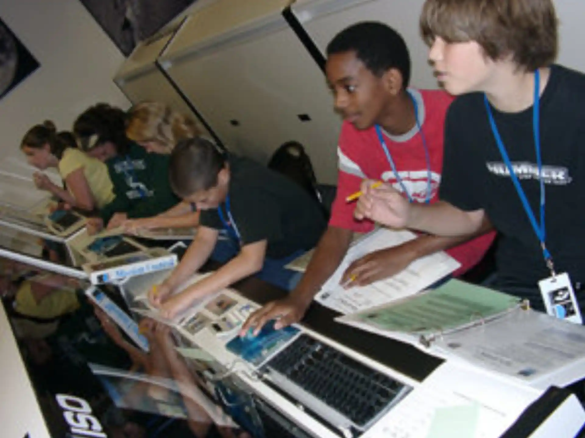 a group of students working on a laptop